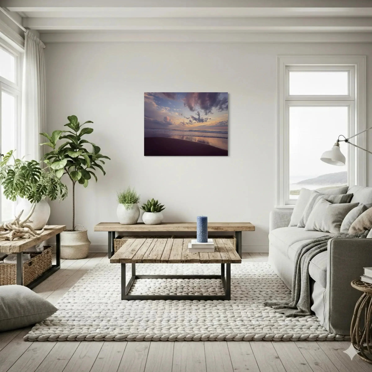Coastal hygee living room with greenery, natural woods and neutral materials with a Outer Banks sunrise wall art.