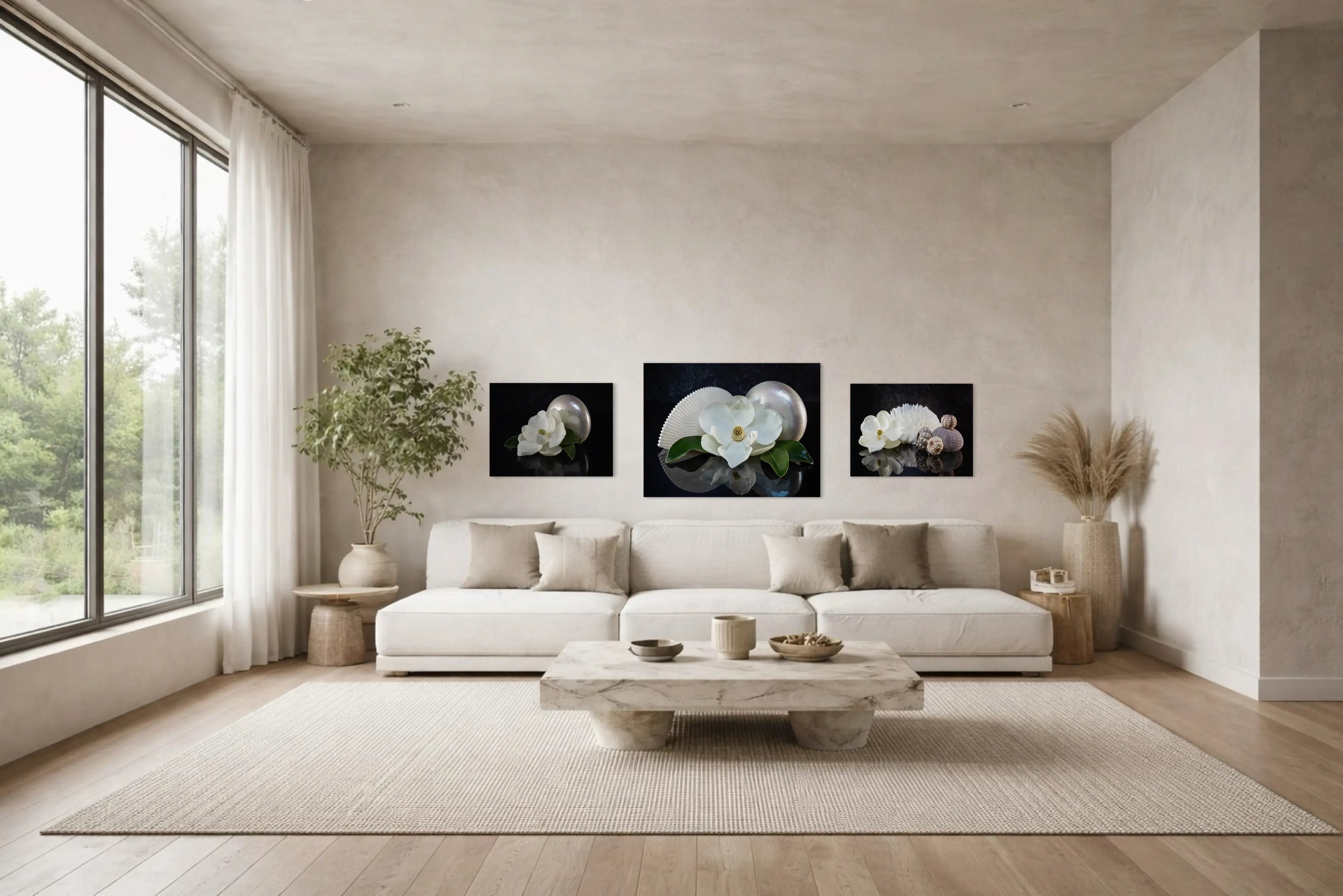 Light coastal living room with magnolia and shell wall art displayed above a neutral sofa, styled for a calm and elegant space