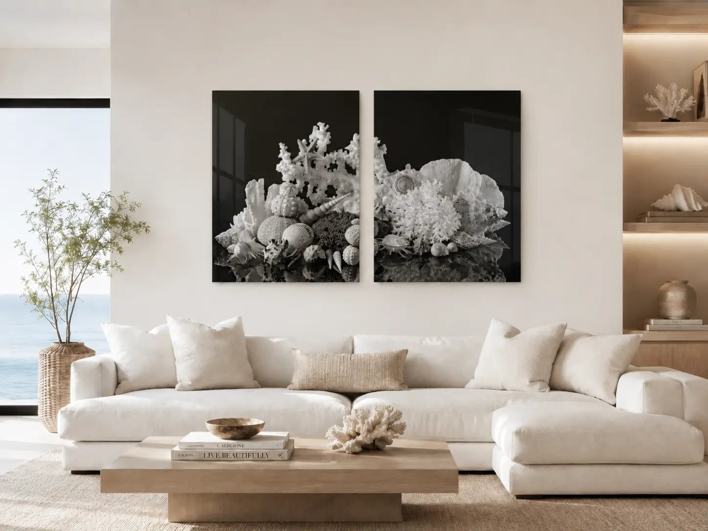 Black and white coral diptych glass wall art displayed above a white sofa in a modern coastal living room.