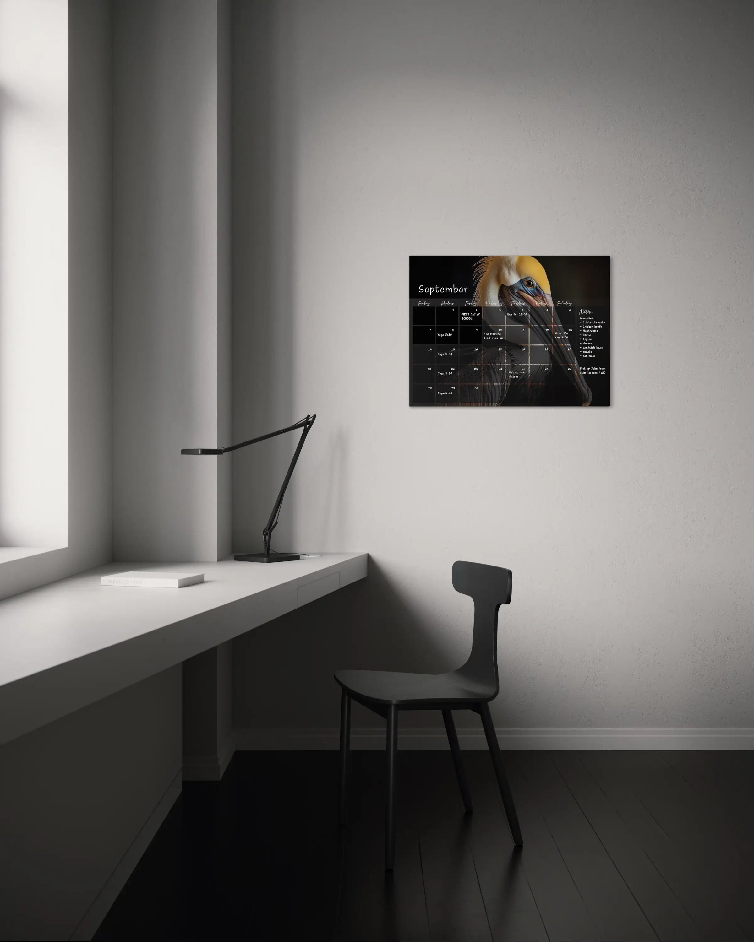 A dry-erase perpetual glass calendar featuring a dramatic, close-up portrait of brown pelican on dark background, with monthly grid and notes section. , office