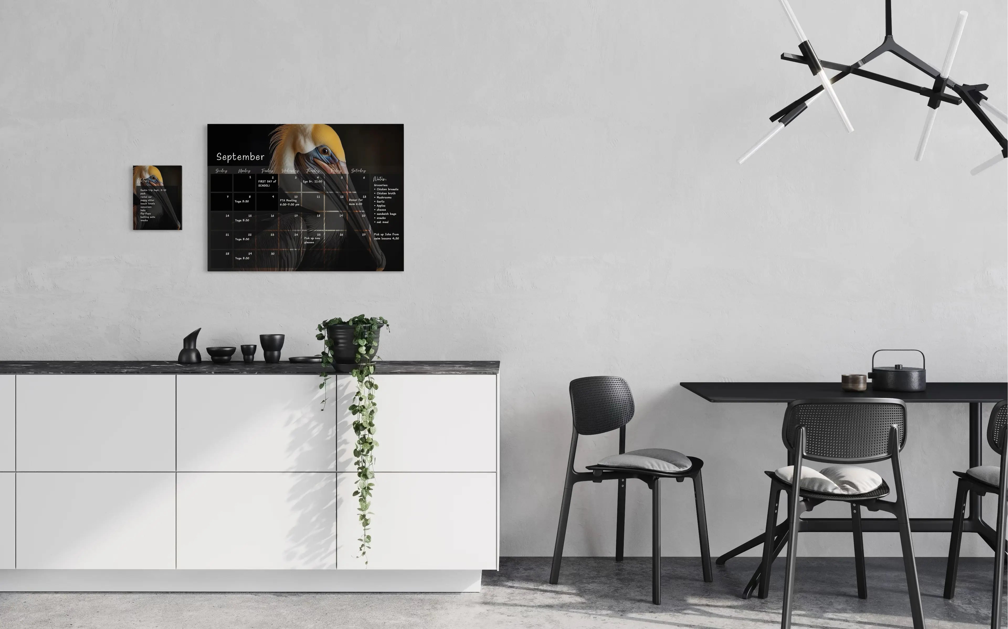 A dry-erase perpetual glass calendar featuring a dramatic, close-up portrait of a brown pelican on dark background, with monthly grid and a notes section, with notes pad