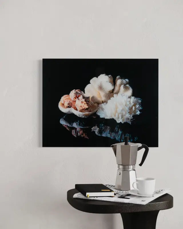 Coastal decor print glass art with coral bowl, shells, and lettuce coral on black background-over small table