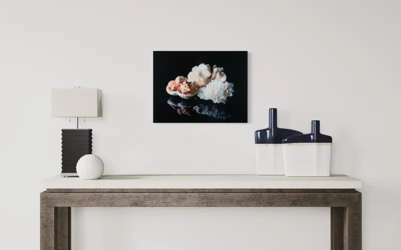 Coastal decor print glass art with coral bowl, shells, and lettuce coral on black background-over small table