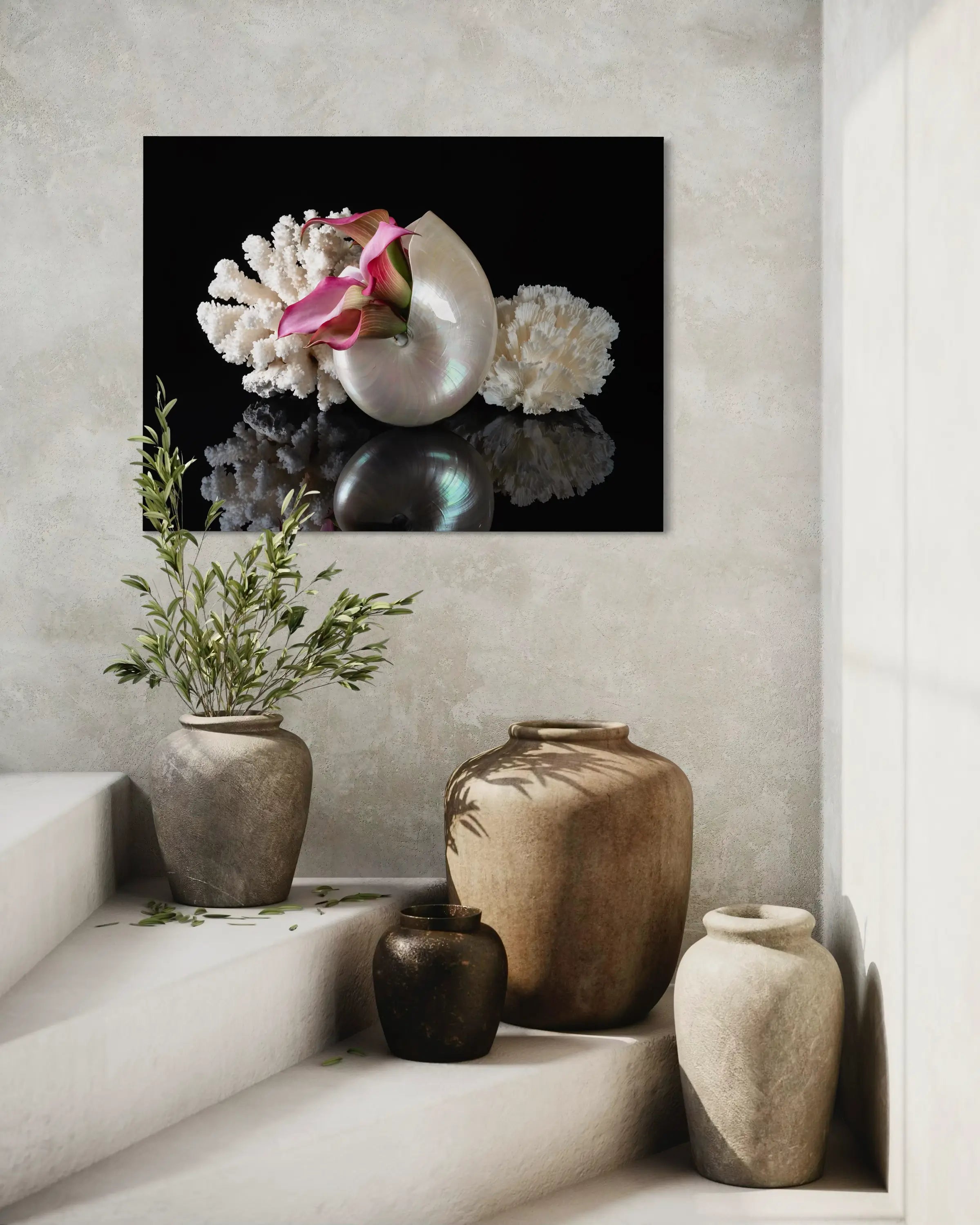 Coastal glass print of a pearl nautilus, coral and pink lilies on black reflective background for ocean wall art.