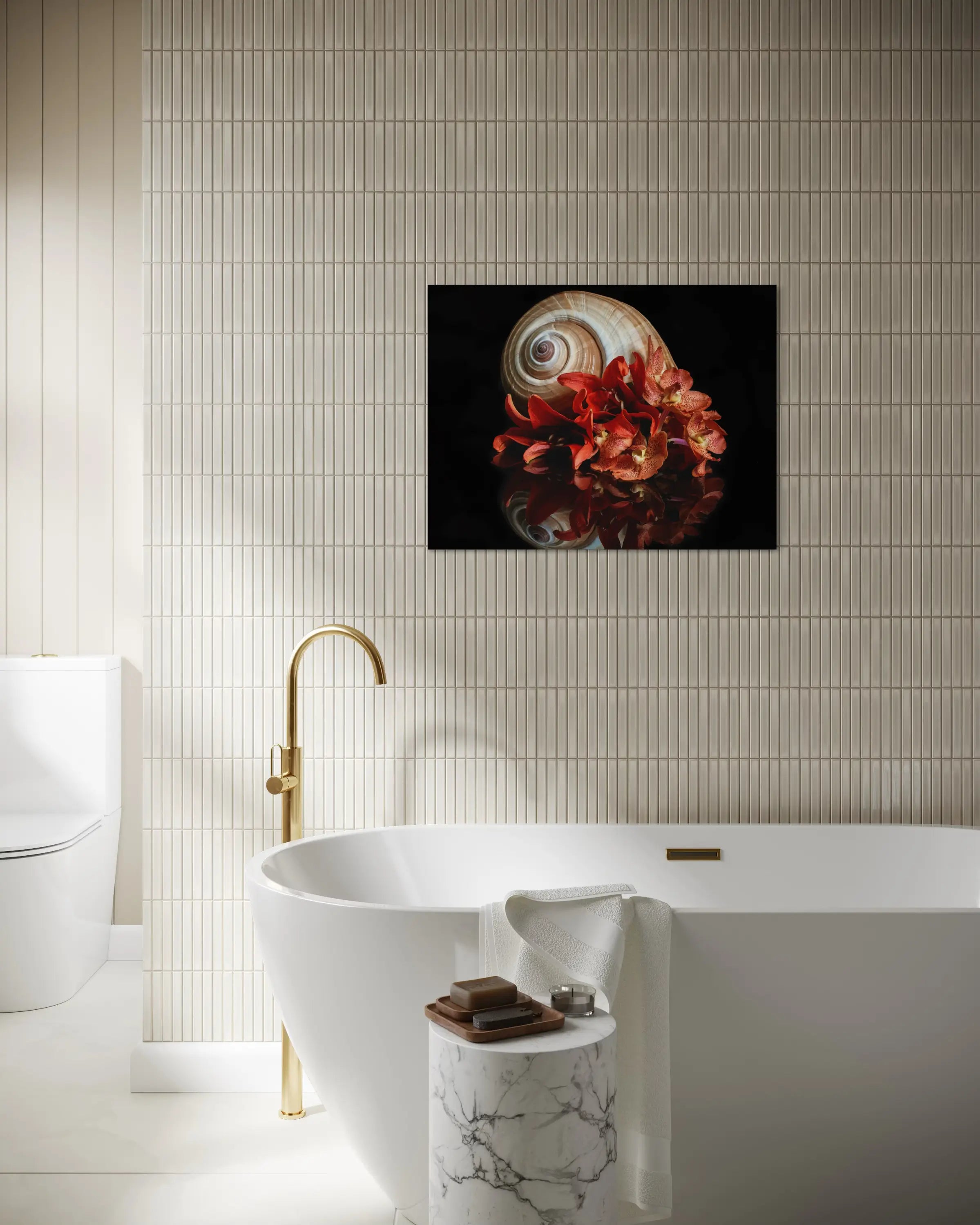 Coastal glass print of a giant tun shell and orange lilies on a reflective black background displayed in bathroom