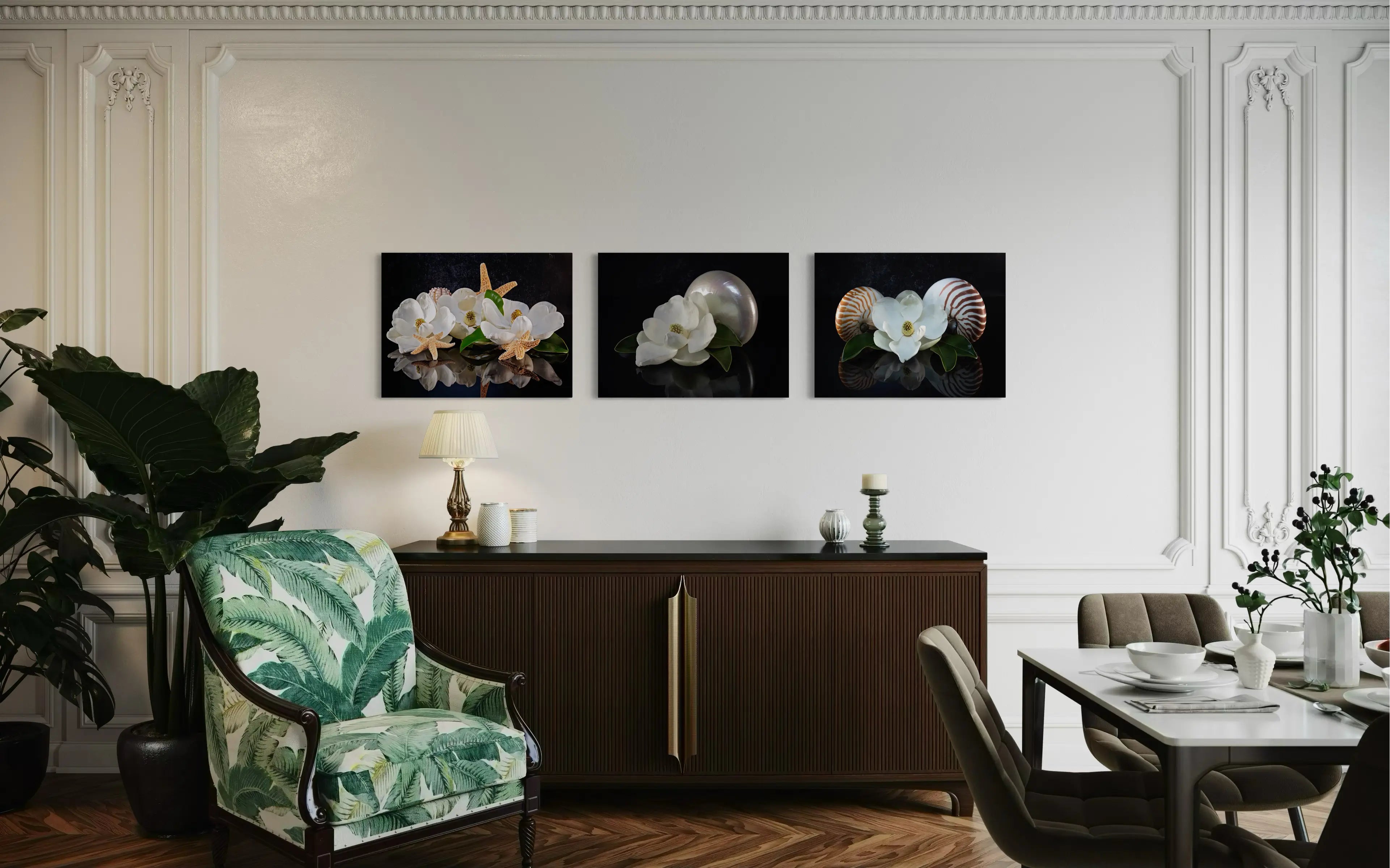 Glass print of 3 magnolia blossoms, starfish and sea urchins on reflective black background displayed with 2 other magnolia prints.
