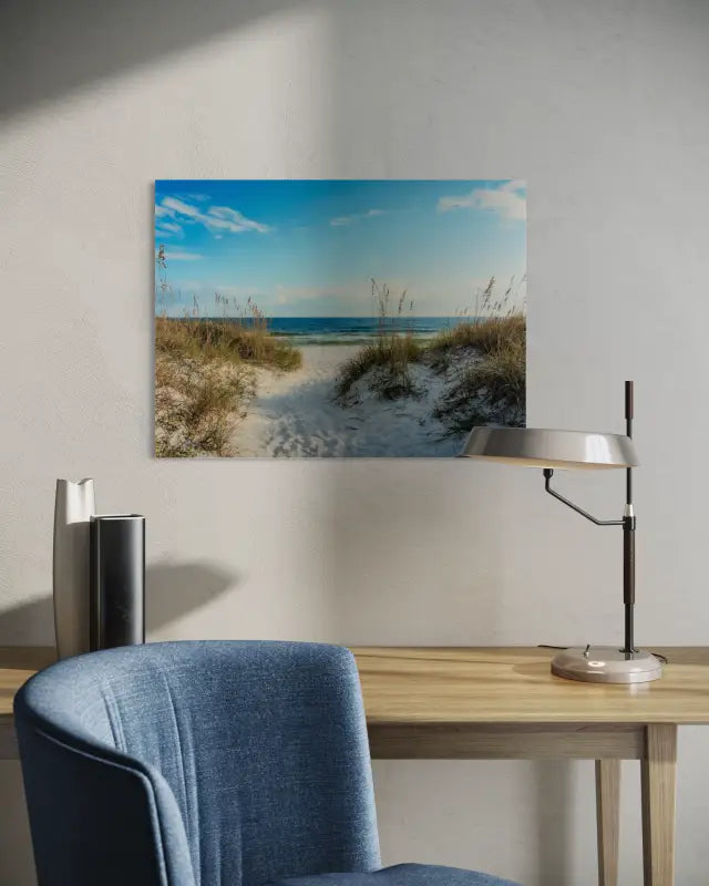 A glass print featuring a pathway winding through white sand dunes with sea oats, leading to a calm ocean horizon_above desk