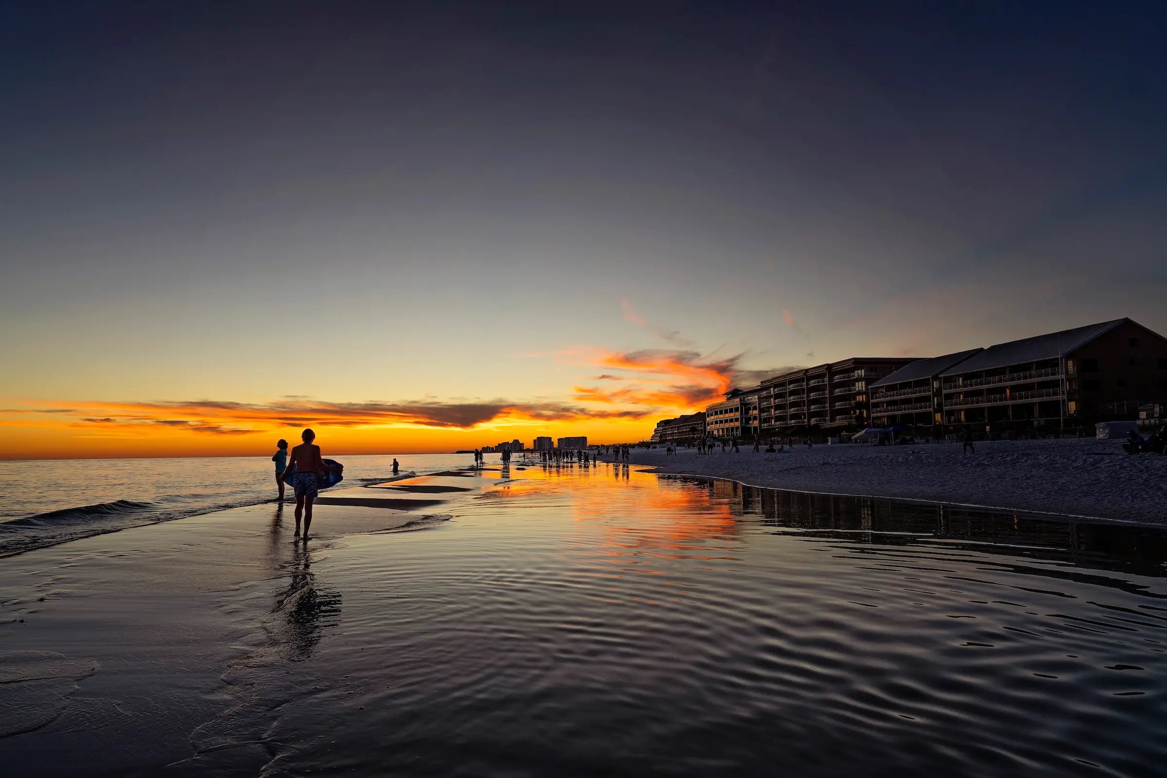 Coastal Glass Print of Miramar Beach sunset with beachgoers, coastal wall art