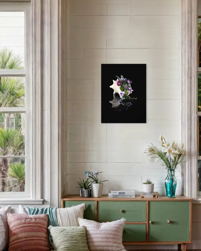 Conch shell with succulents and purple flowers on black glass print, coastal living