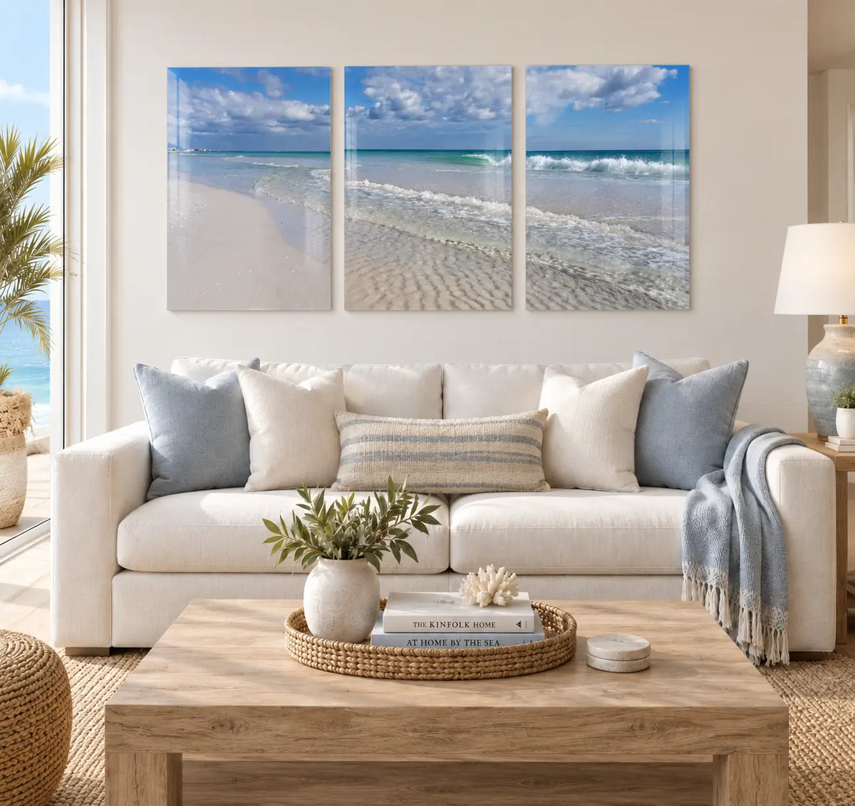 Crystal Clear Beach Triptych Glass Print displayed above a sofa in a bright modern coastal living room