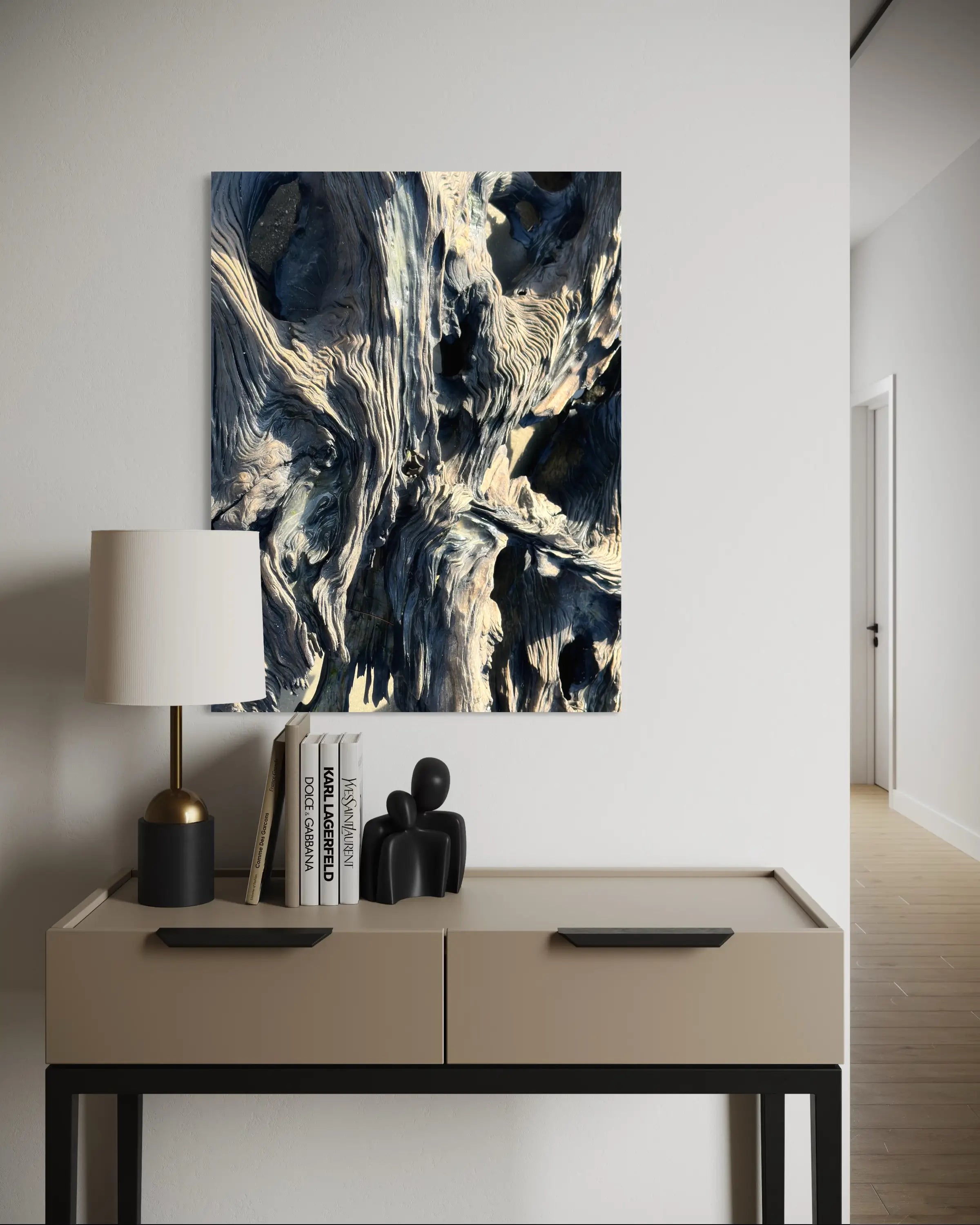 Driftwood texture coastal glass print displayed above a small wooden side table with decorative accents.