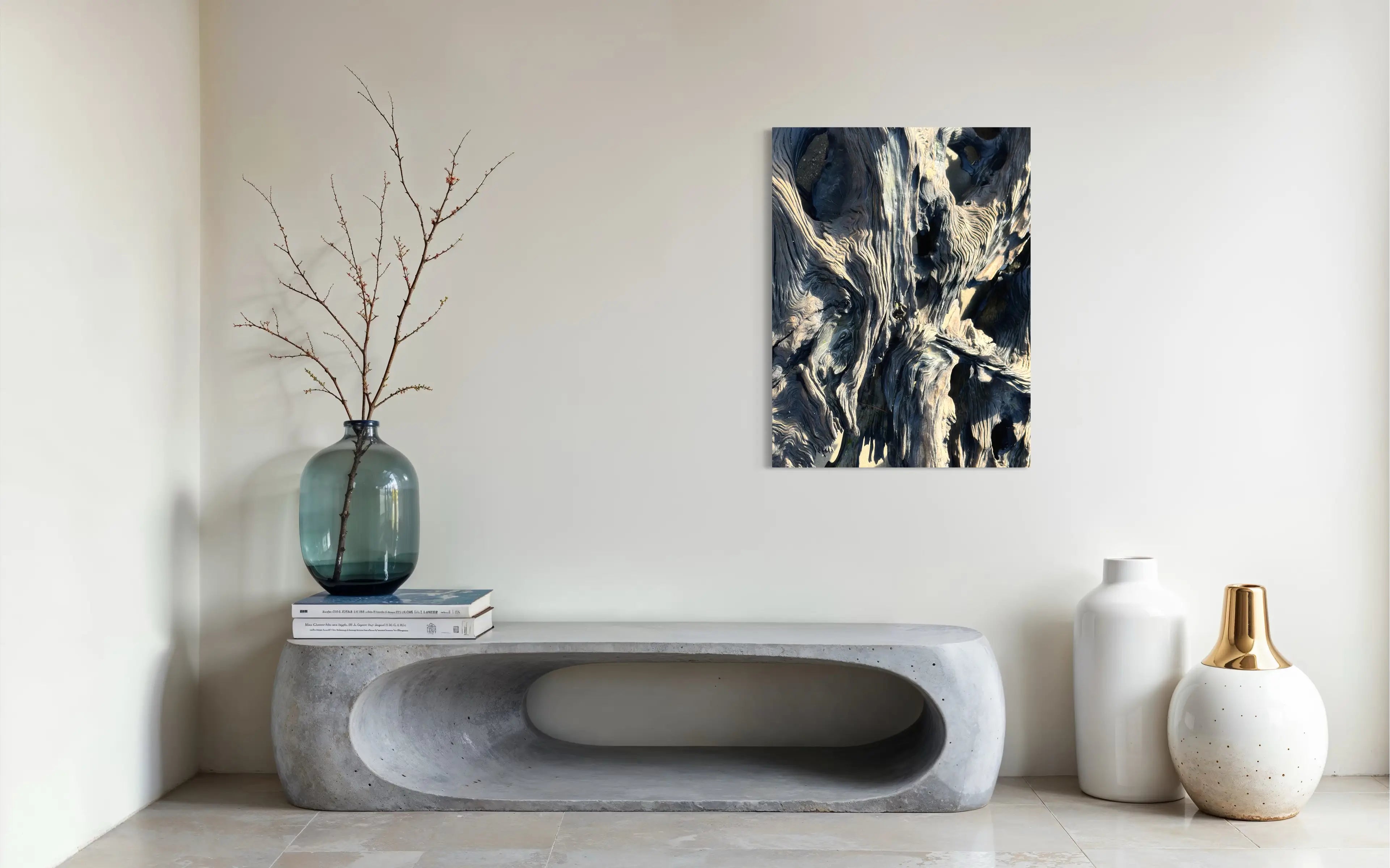 Large driftwood texture coastal glass print in a modern entryway above a sleek stone bench.
