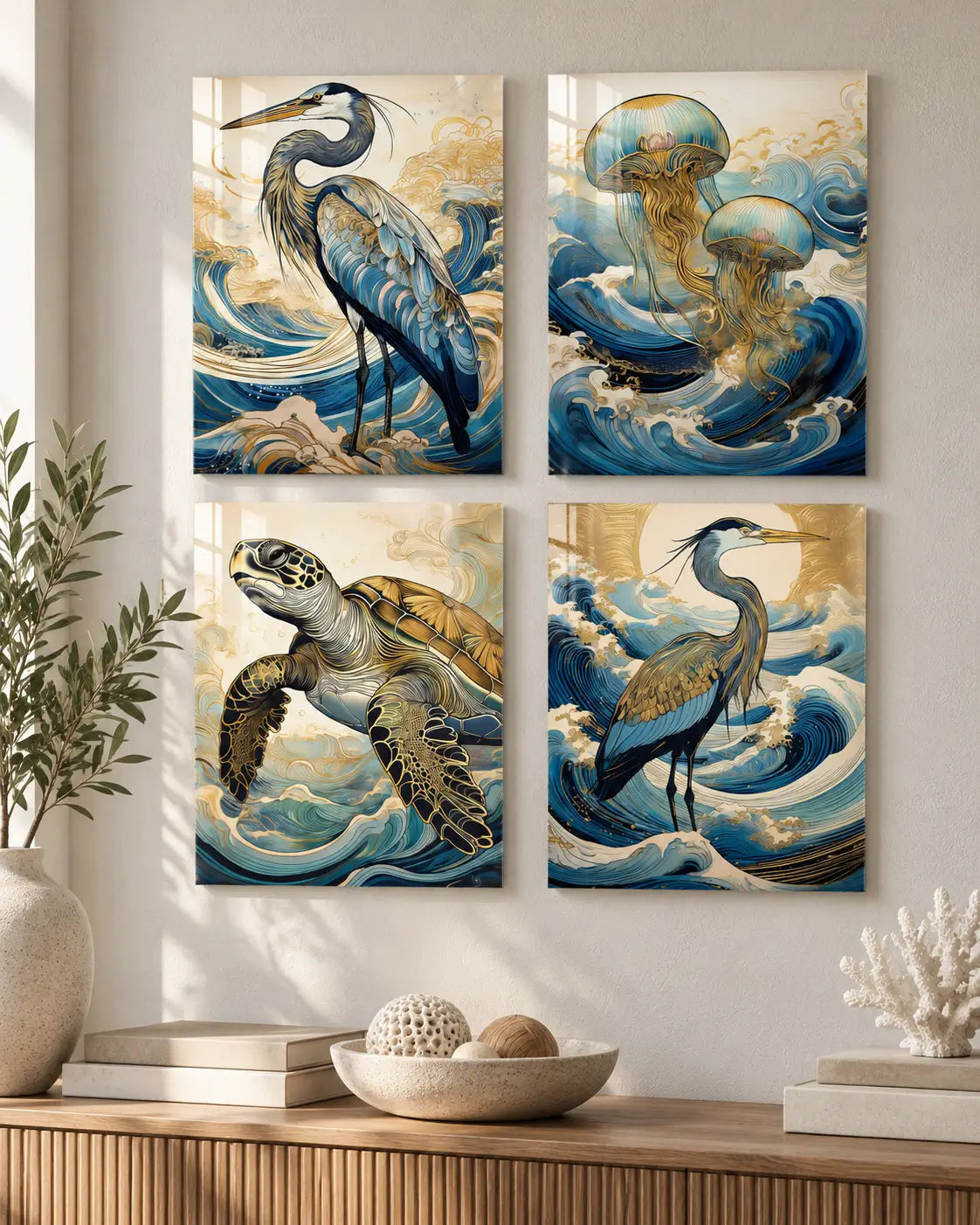 Four-piece coastal glass wall art set featuring two great blue herons, golden jellyfish, and a sea turtle displayed in a modern coastal interior.