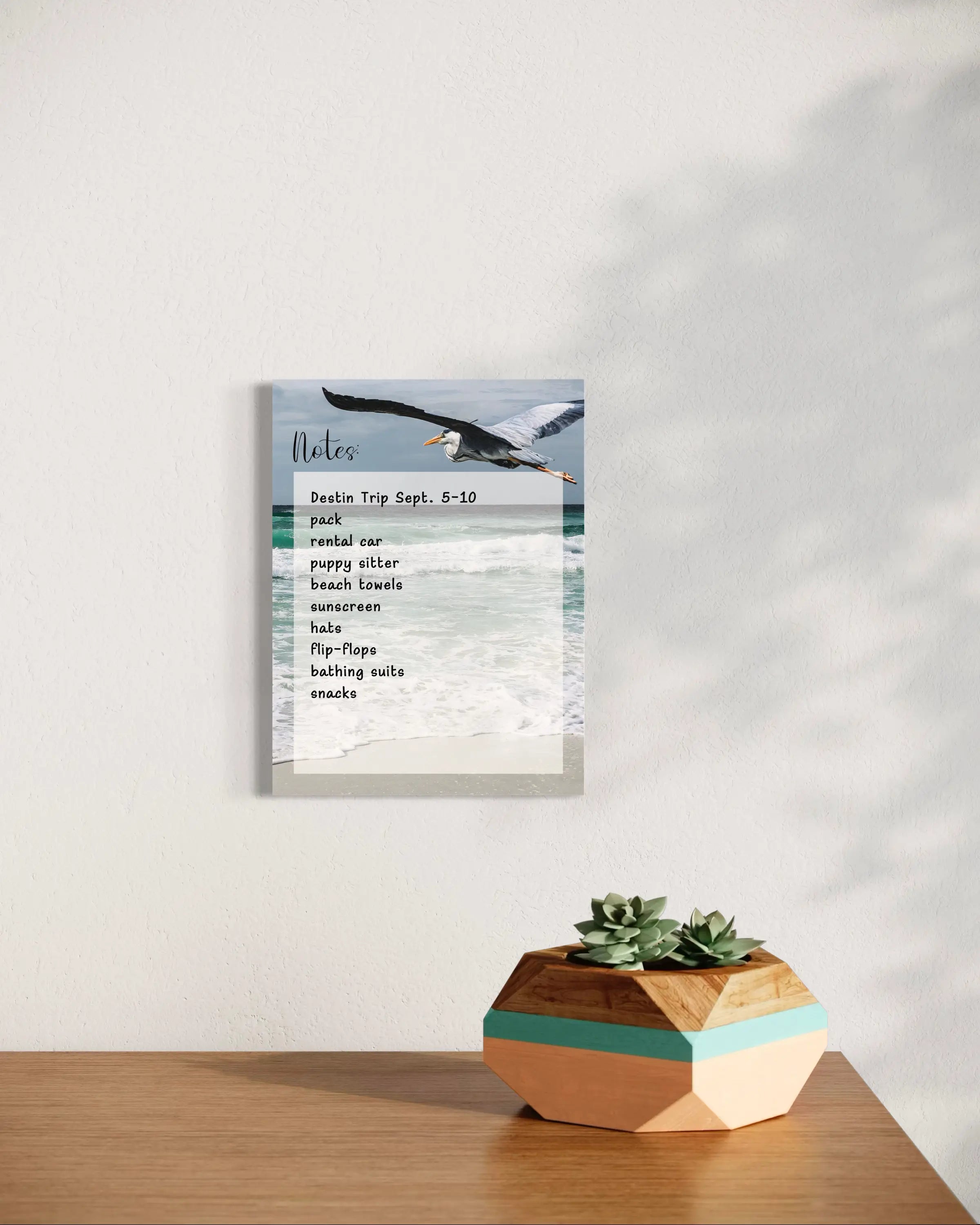 A reusable glass notes board featuring a Great Blue Heron in flight over ocean waves, with a blank dry-erase surface for notes and to-do lists.