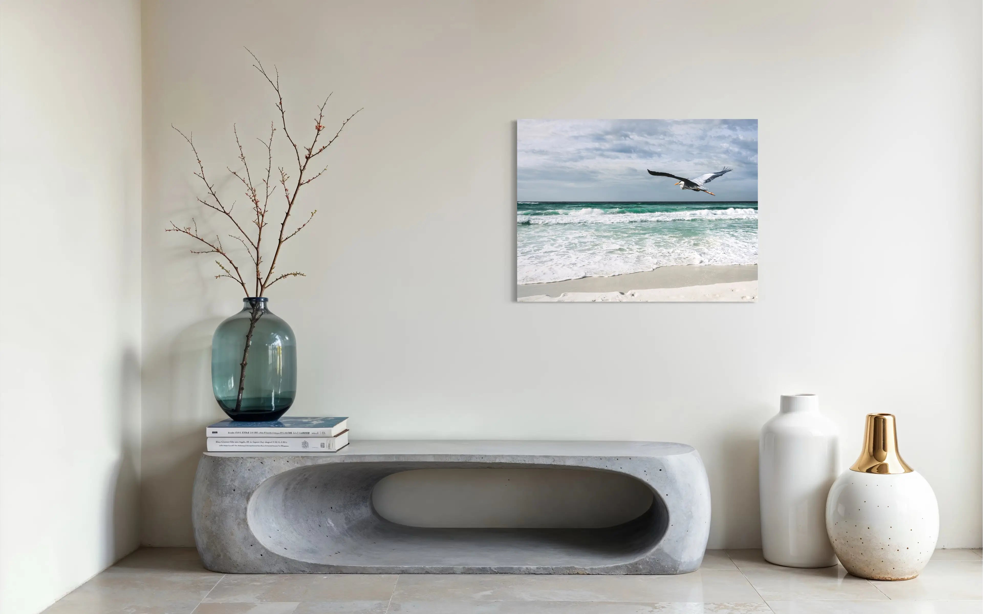 Great blue heron in flight over emerald Gulf waves at Henderson Beach, coastal glass print wall art for modern beach decor.