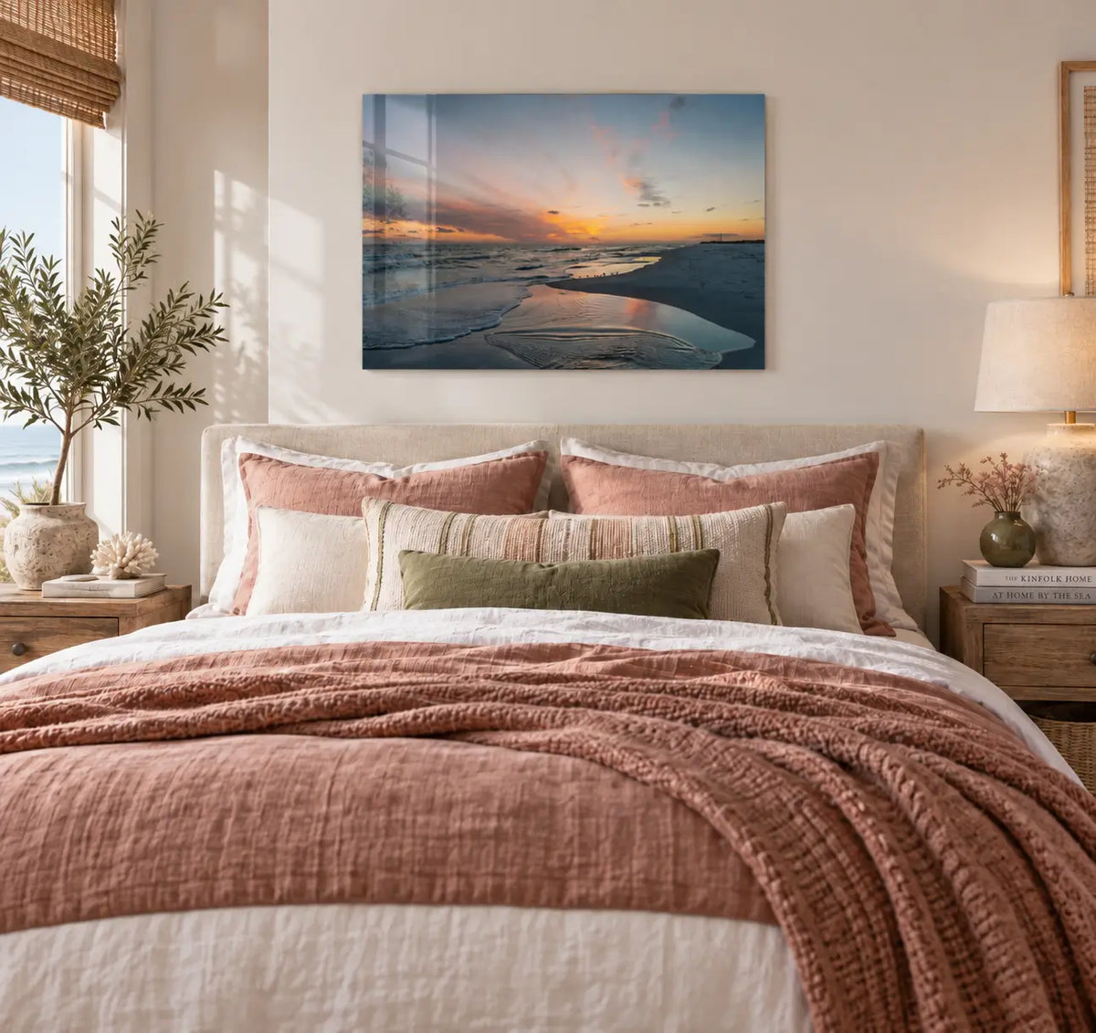 Coastal bedroom with earthy rose bedding and a Gulf Coast sunset glass print displayed above the bed.