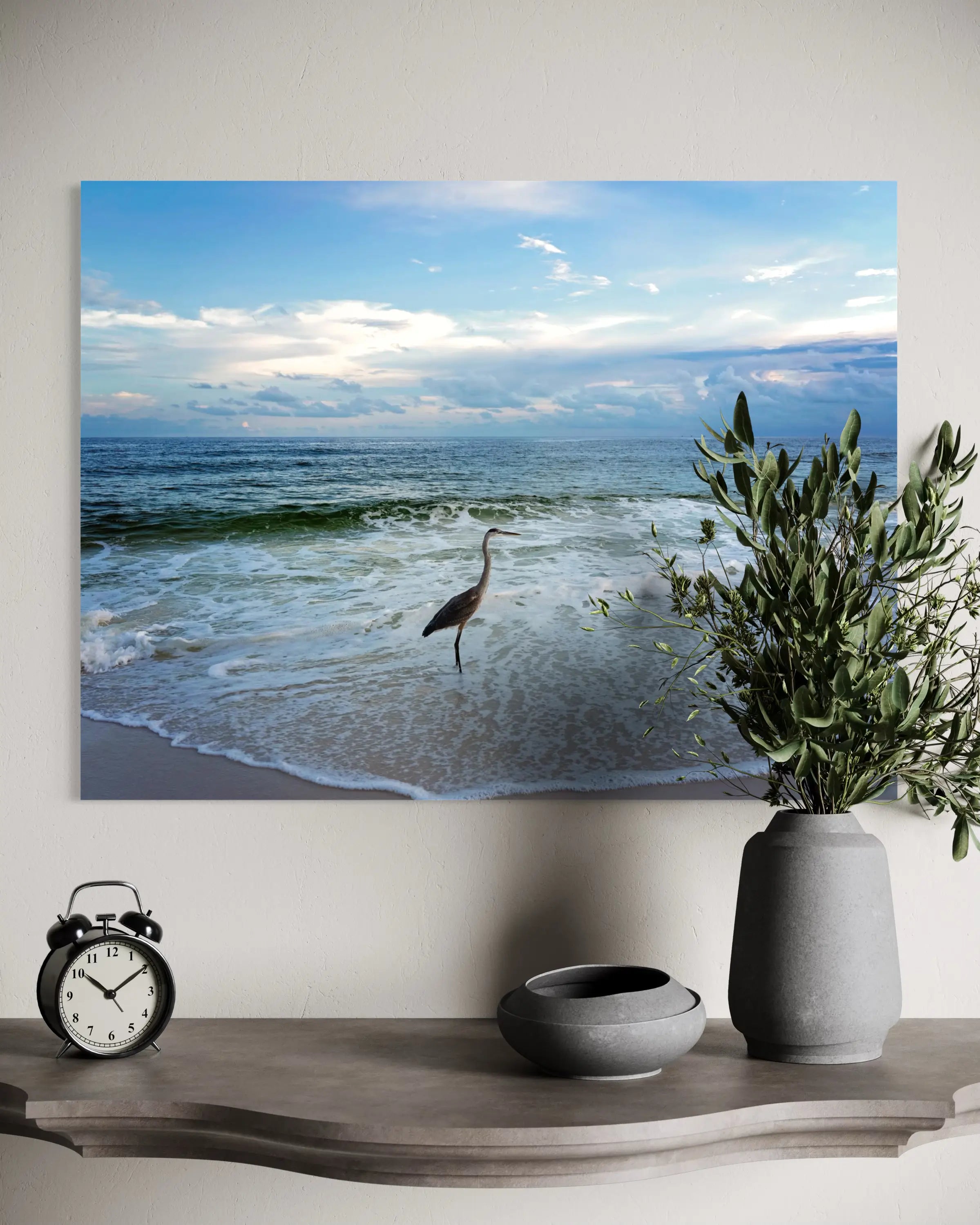 Heron on shoreline under cloudy sky, coastal glass art