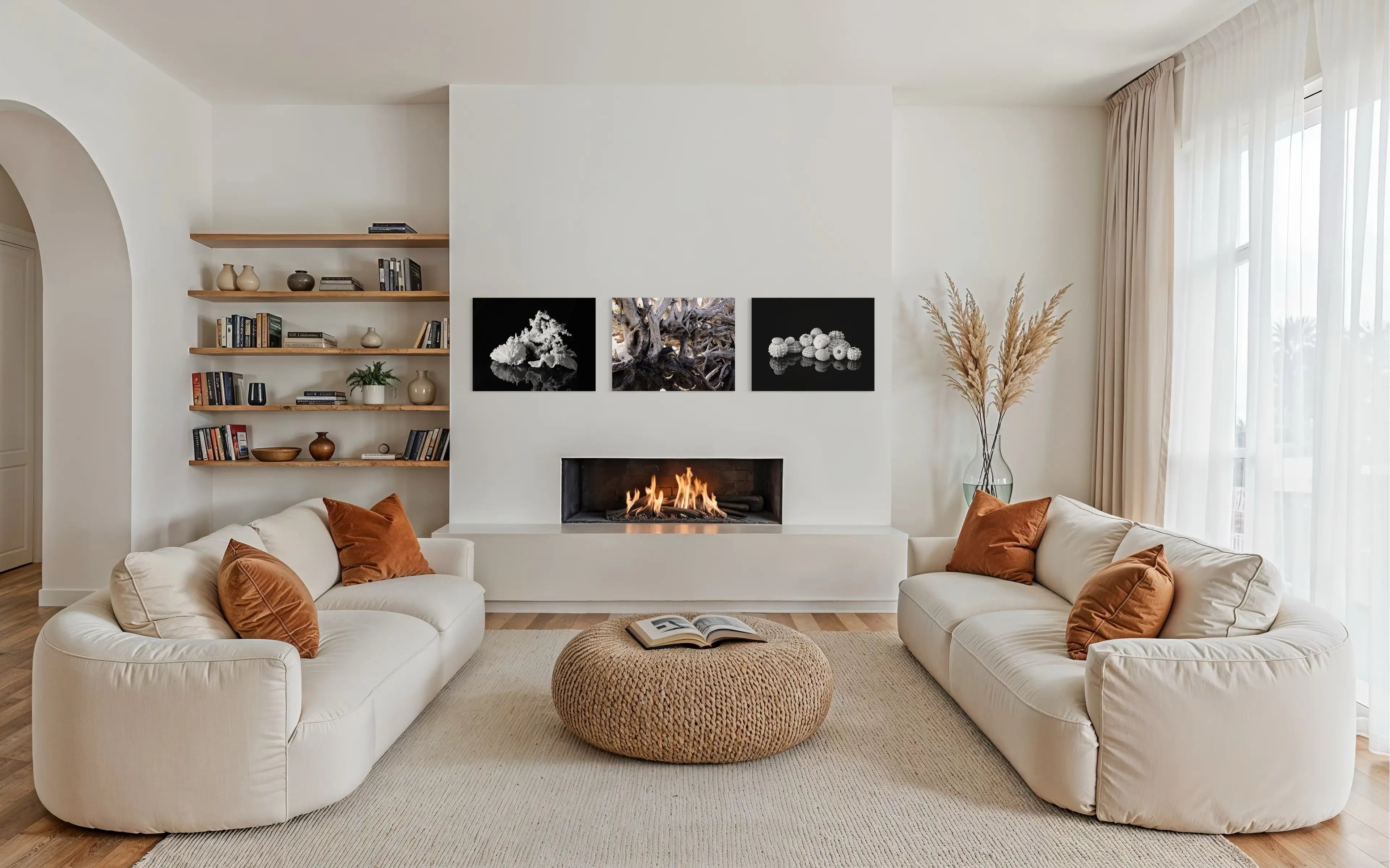 Coastal glass prints above fireplace – driftwood wall art with seashell and coral prints for beach house style.
