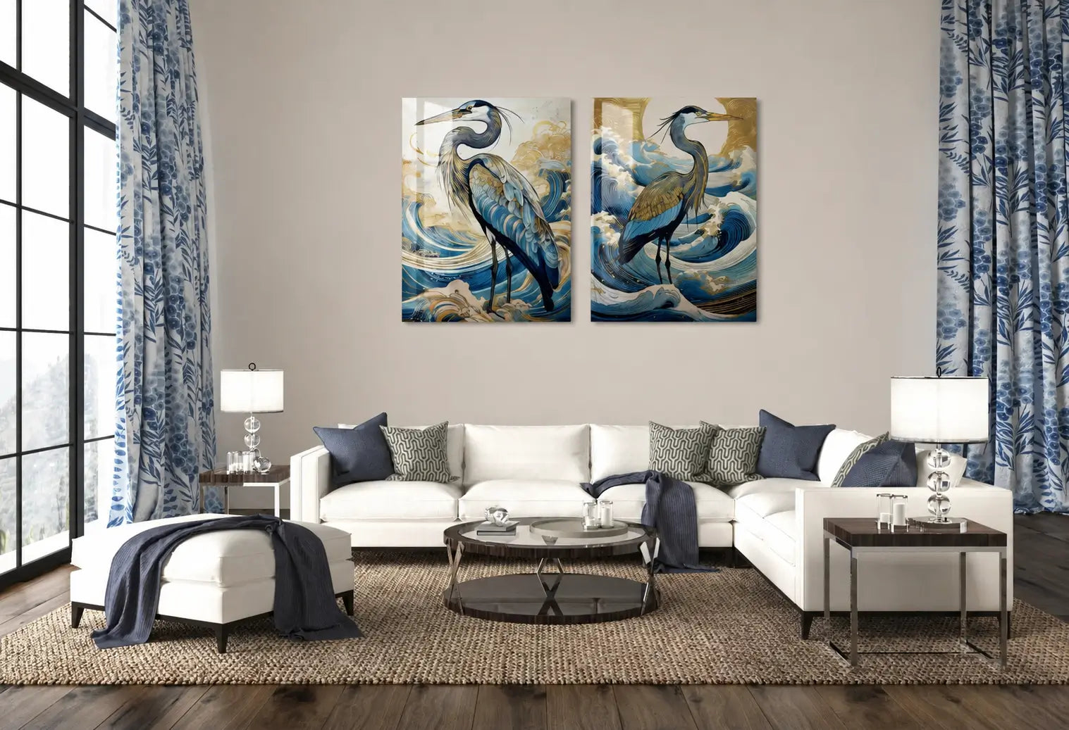 Elegant living room styled with two gold-accented Blue Heron glass prints hung above a white sectional sofa, showcasing luxury coastal décor in blue and gold tones with natural light and ocean-inspired textiles.
