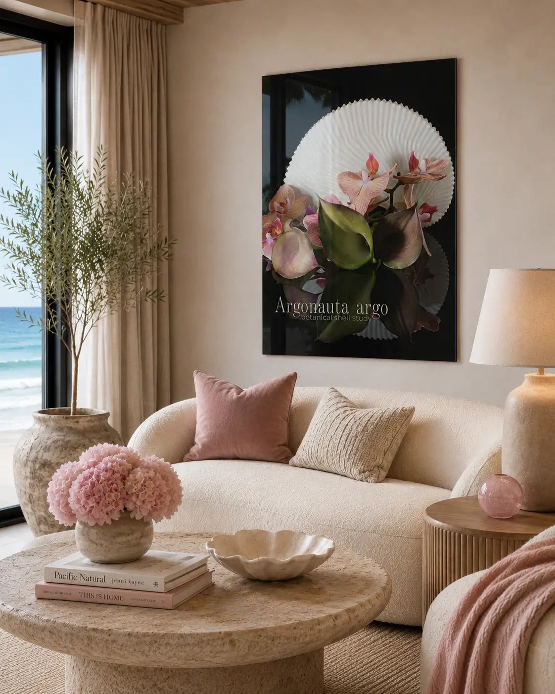 Coastal living room with a beige sofa, coffee table, and a glass print featuring paper nautilus, lilies and orchids.