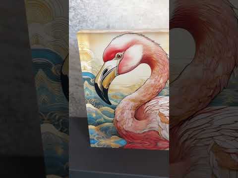 Video of a 3D coastal acrylic block print of a pink flamingo in a tropical setting,