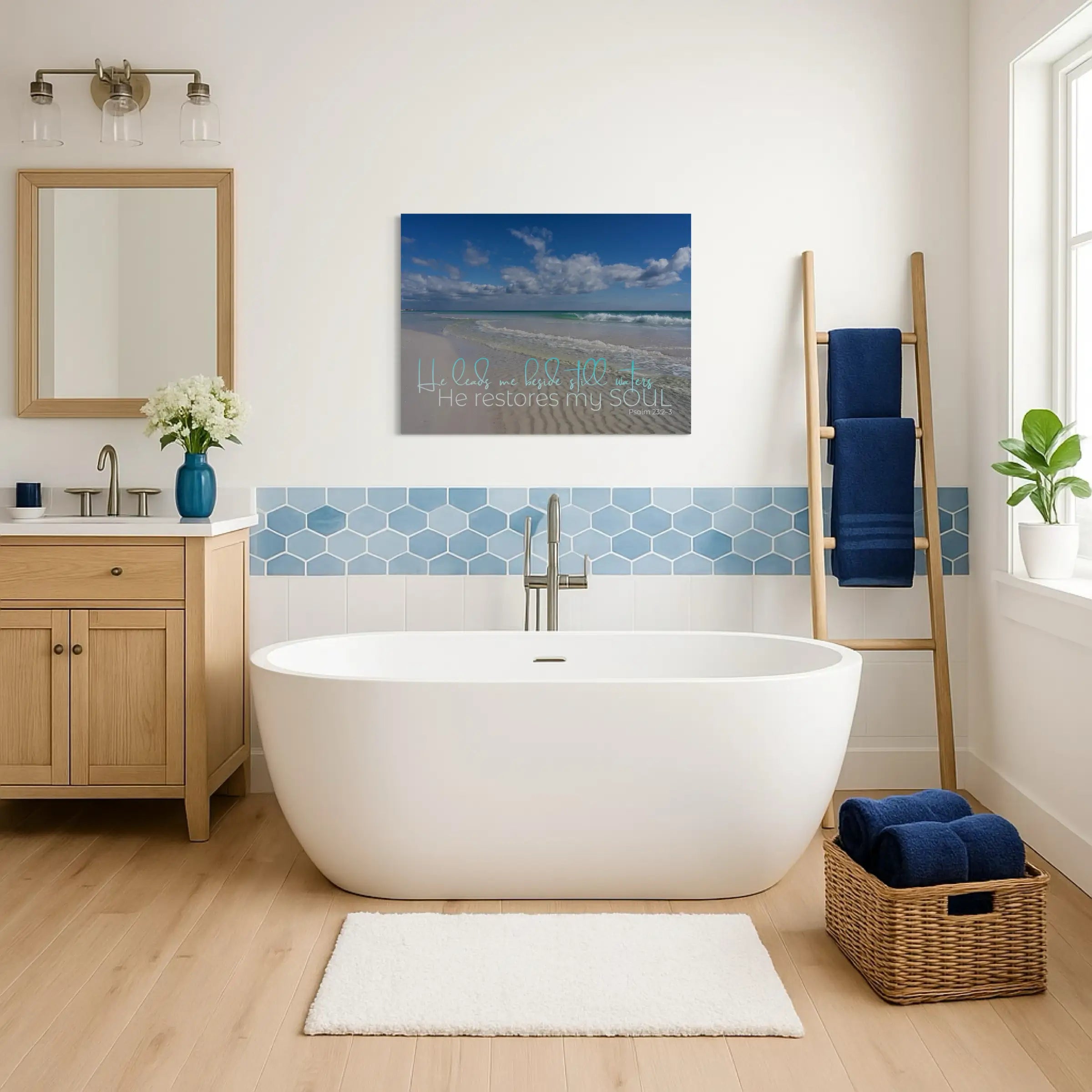 Psalm 23 scripture coastal wall art glass print displayed above a white soaking tub in a serene coastal bathroom, adding peace and spiritual calm.