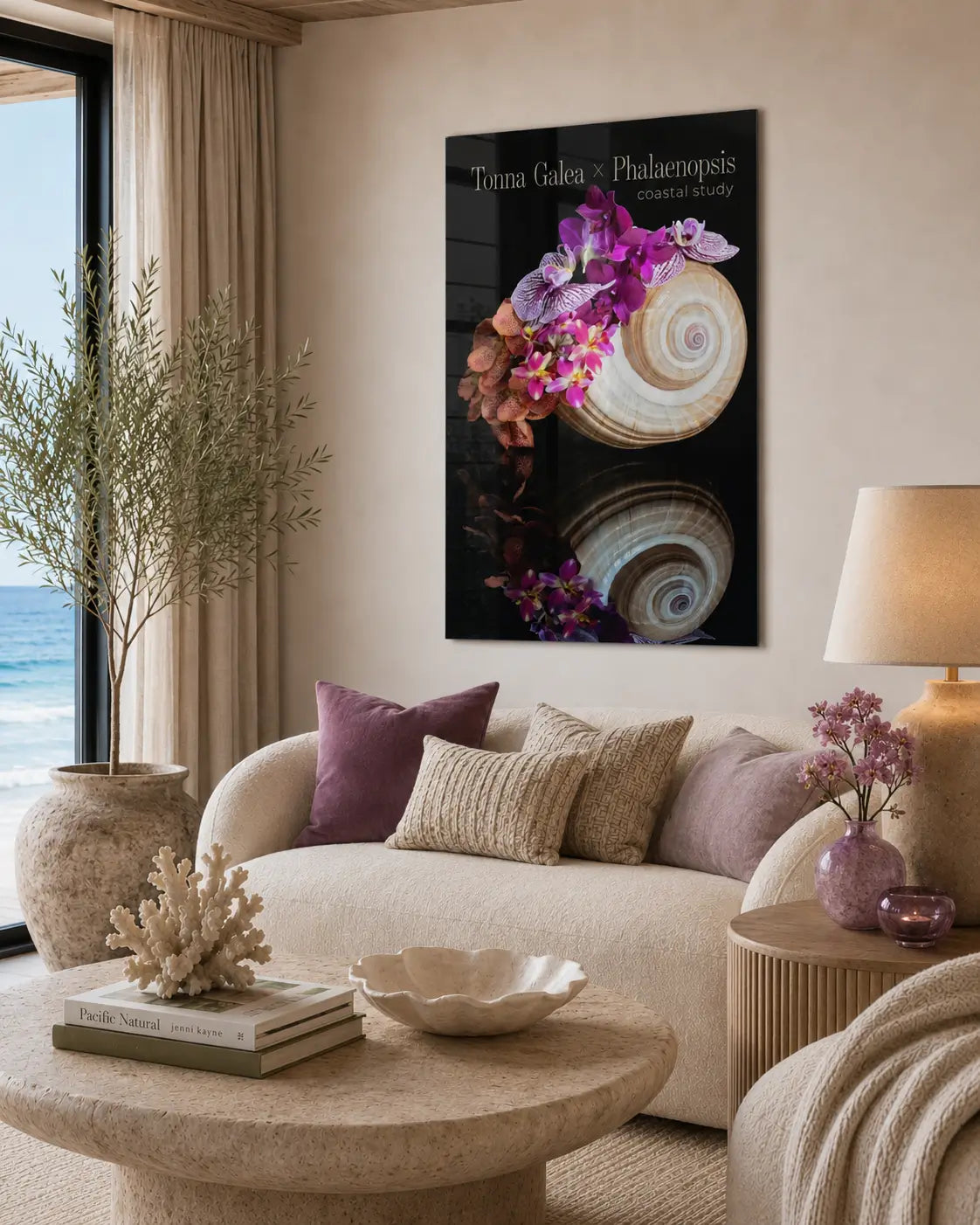 High-end neutral coastal living room with a curved cream sofa and a glossy frameless glass print of a spiral shell with vivid purple orchids mounted above the seating area.