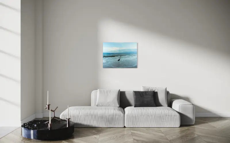 Heron on shoreline with gentle waves, serene coastal glass print for beach scene decor-living room