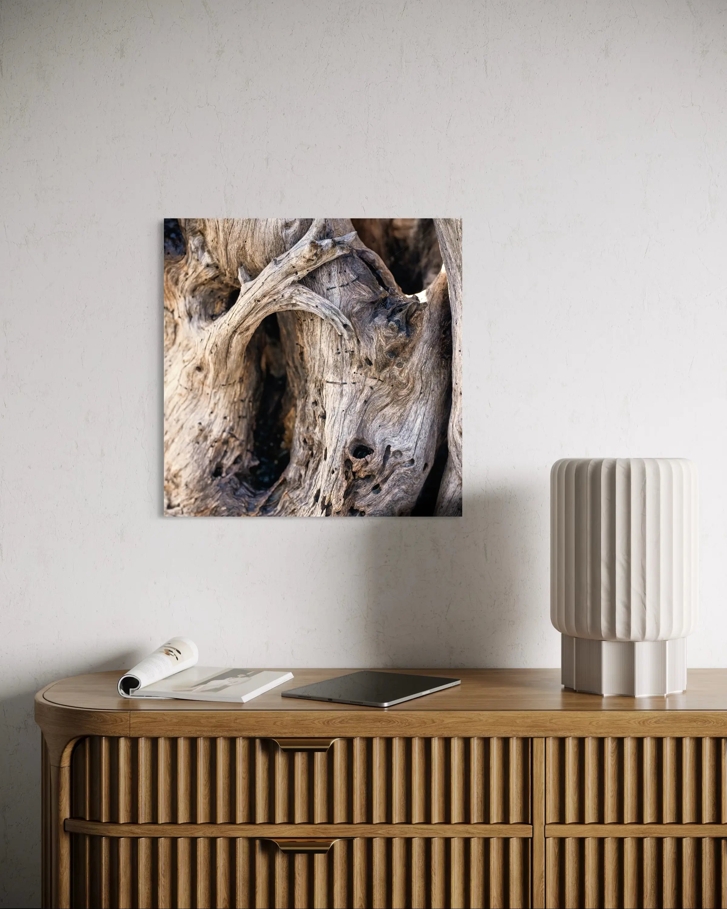 Weathered Grace Driftwood Art – coastal glass print displayed above a side table with coastal accessories, creating a warm and welcoming beach house vignette.