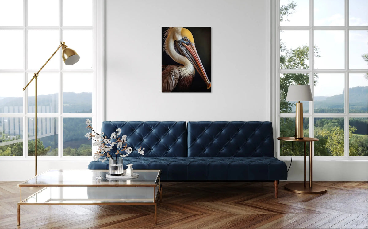 Brown Pelican glass wall art displayed in a bright coastal living room with a navy blue sofa and gold accents, showcasing vibrant feather detail and luminous color.