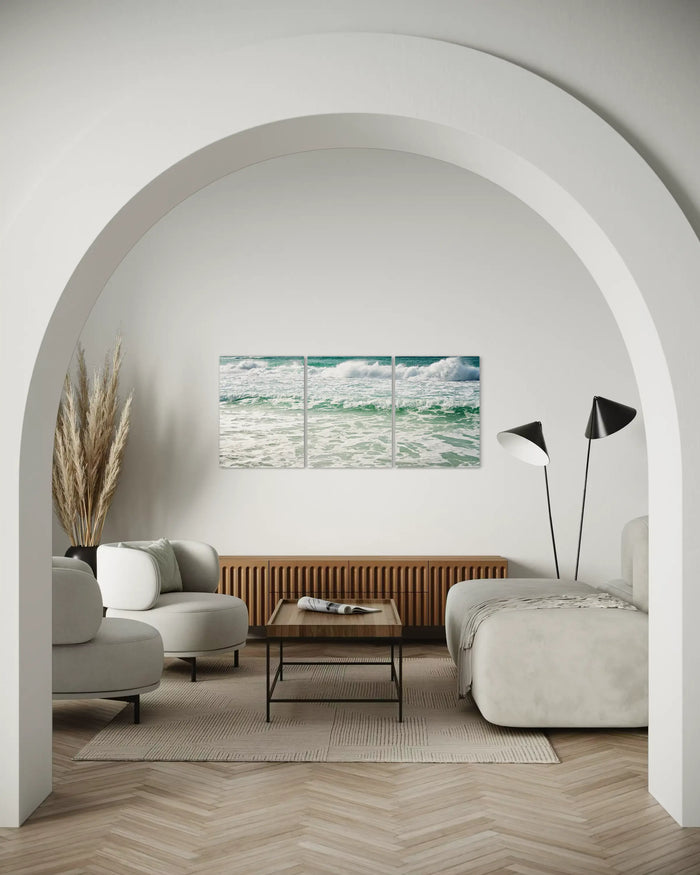 California classic coastal living room with an ocean wave triptych glass print.