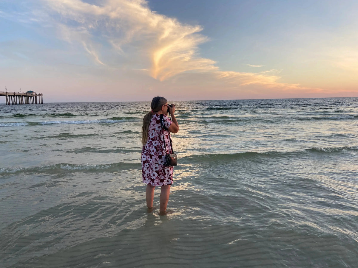 Echoes of theSea photographer taking photos of a heron with a Gulf Coast sunset