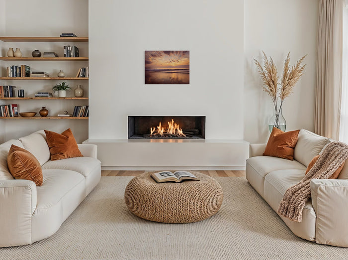 A cozy living room with layered coastal decor, featuring a textured throw blanket, natural wood furniture, and a sea-inspired art print on the wall.