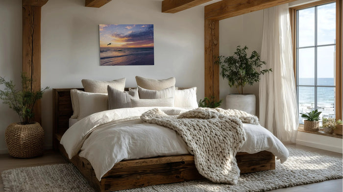 Coastal hygge home decor shown in a bedroom with soft neutrals, natural light and a Echoes sunset glass print.