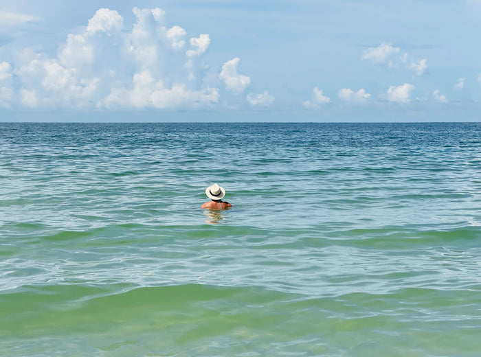 Person standing quietly in the ocean, reflecting the meaning of thalassophile and a deep connection to the sea.