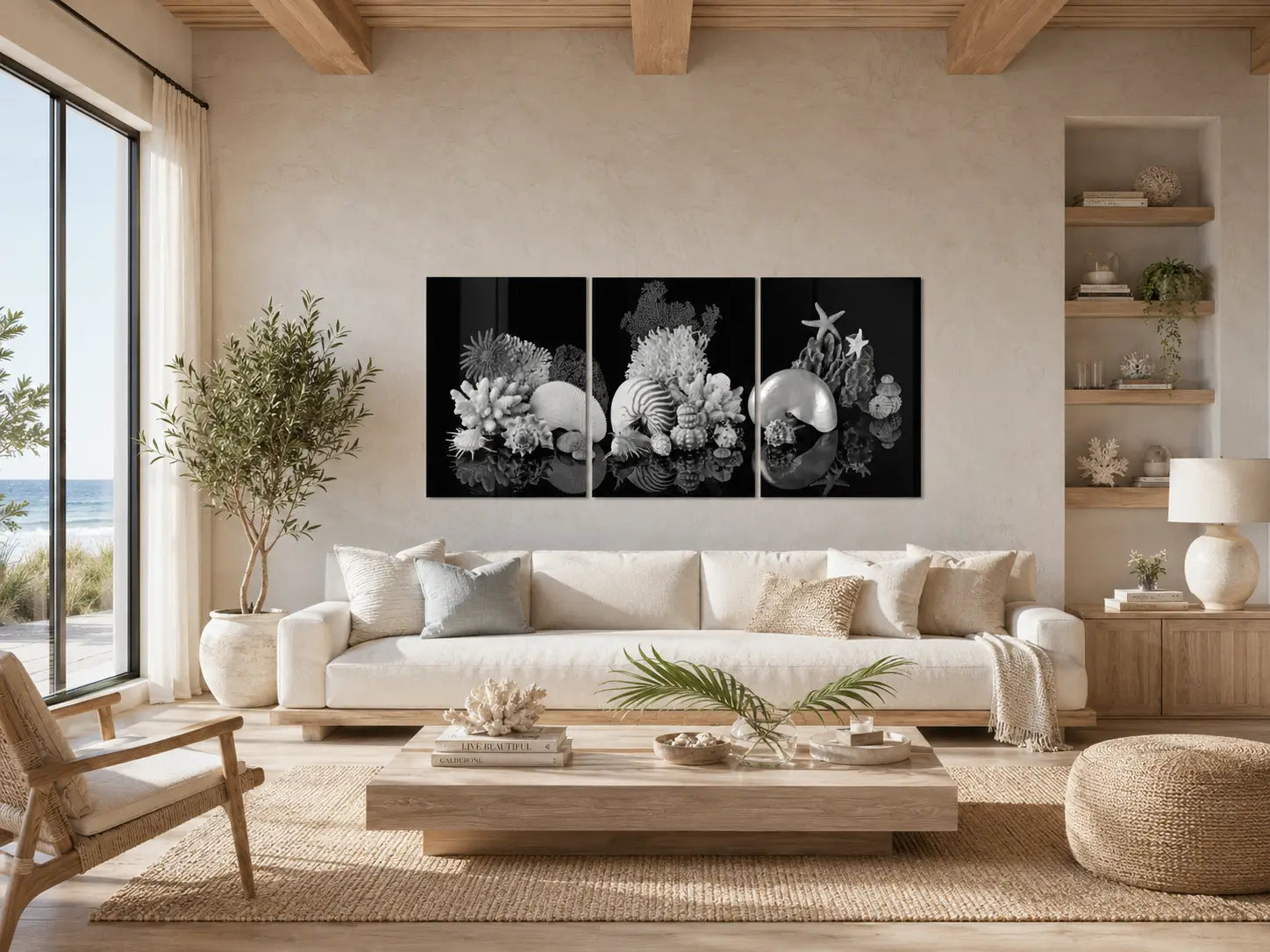 Black-and-white nautilus shell triptych displayed above a neutral sofa in a modern coastal living room.