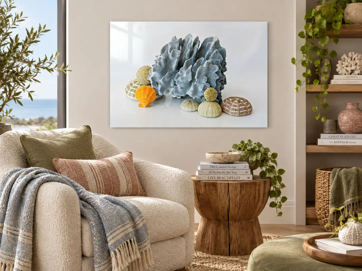 Blue Coral & Sea Urchins coastal glass print styled in a serene coastal reading nook with layered blue, green, and earthy neutral tones.