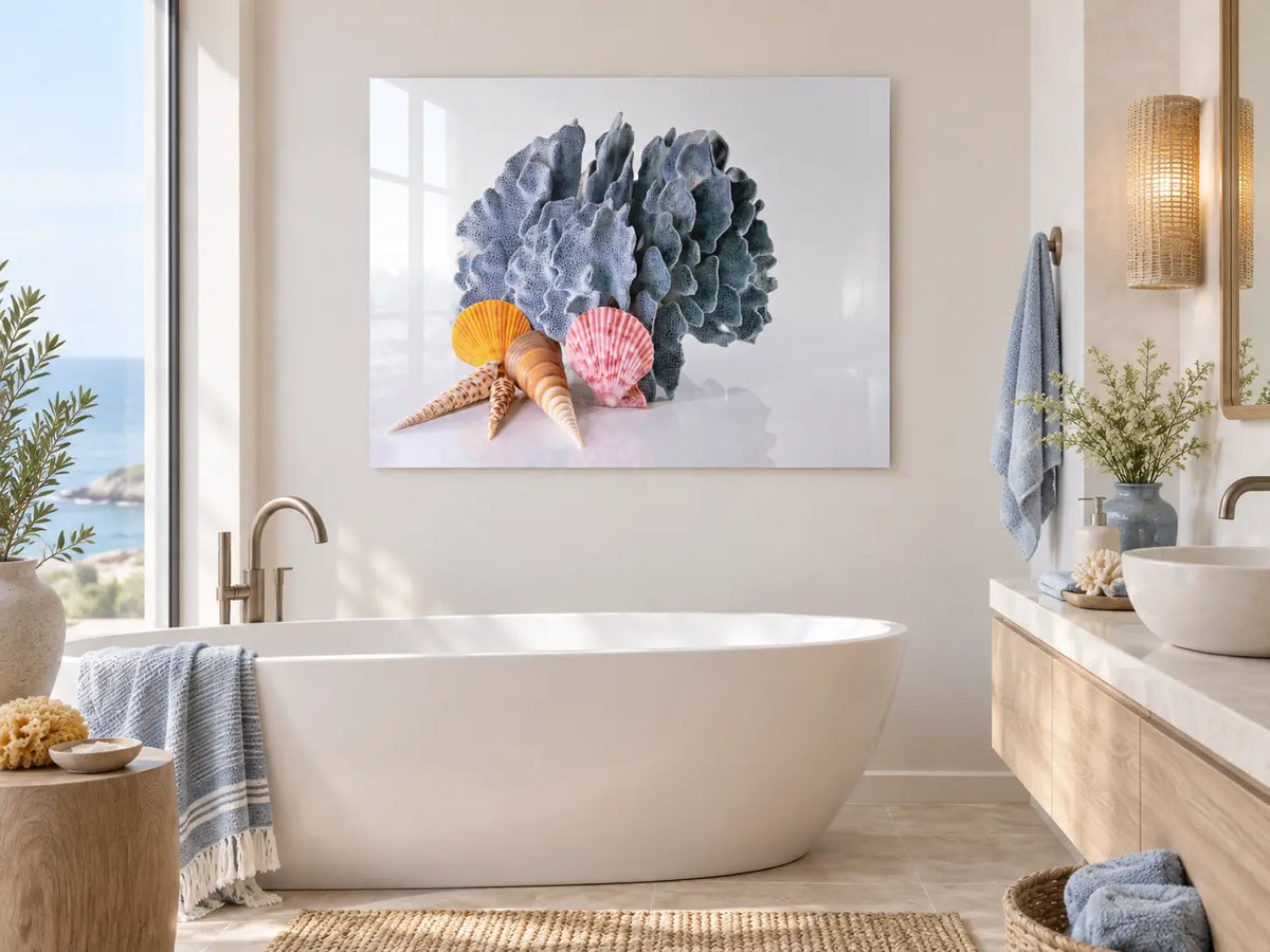 Blue Coral Seashells Coastal Glass Print styled above a bathtub in a modern coastal bathroom with soft neutral tones and spa-like decor.