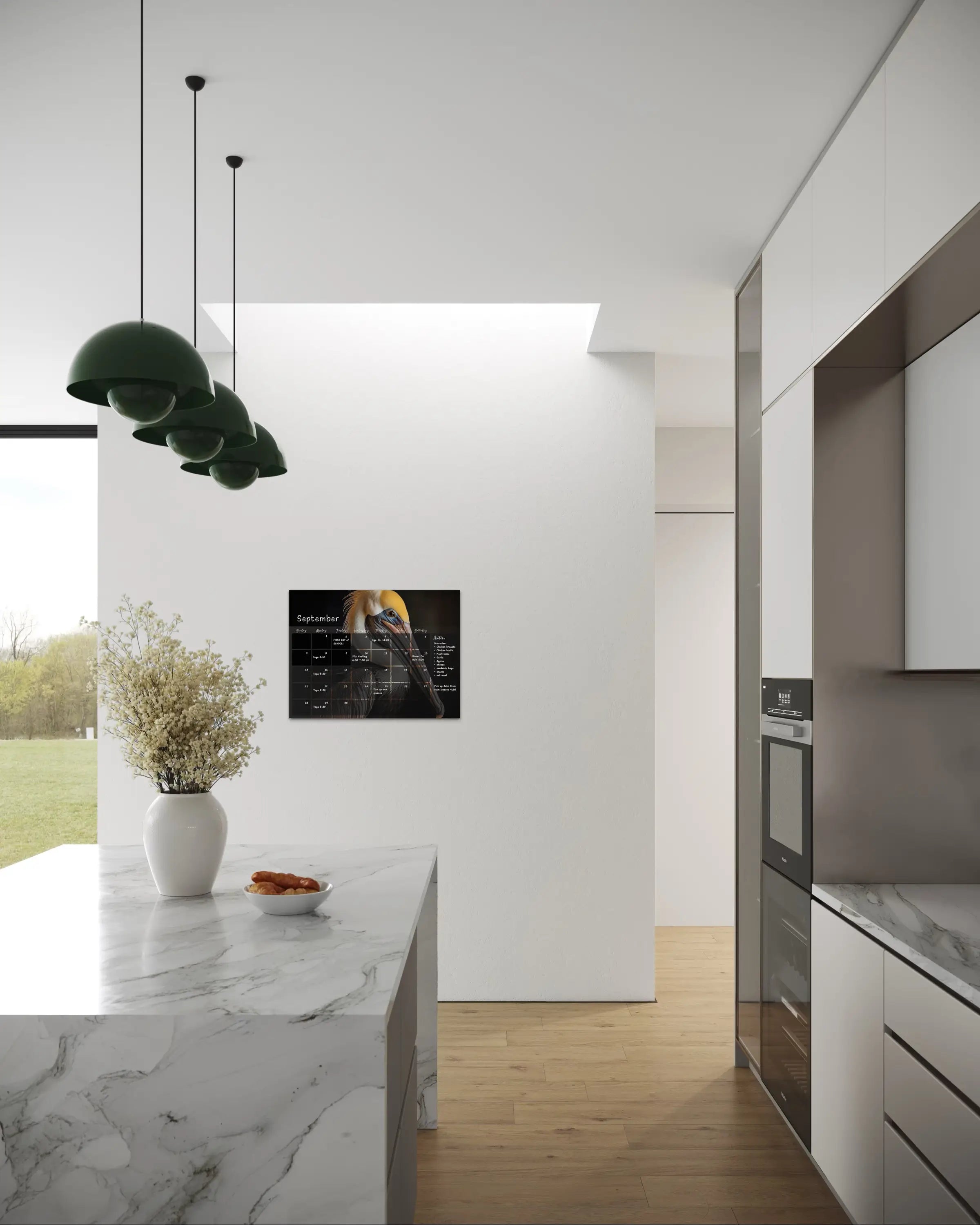 A dry-erase perpetual glass calendar featuring dramatic, close-up portrait of brown pelican on dark background, with monthly grid and notes section in kitchen