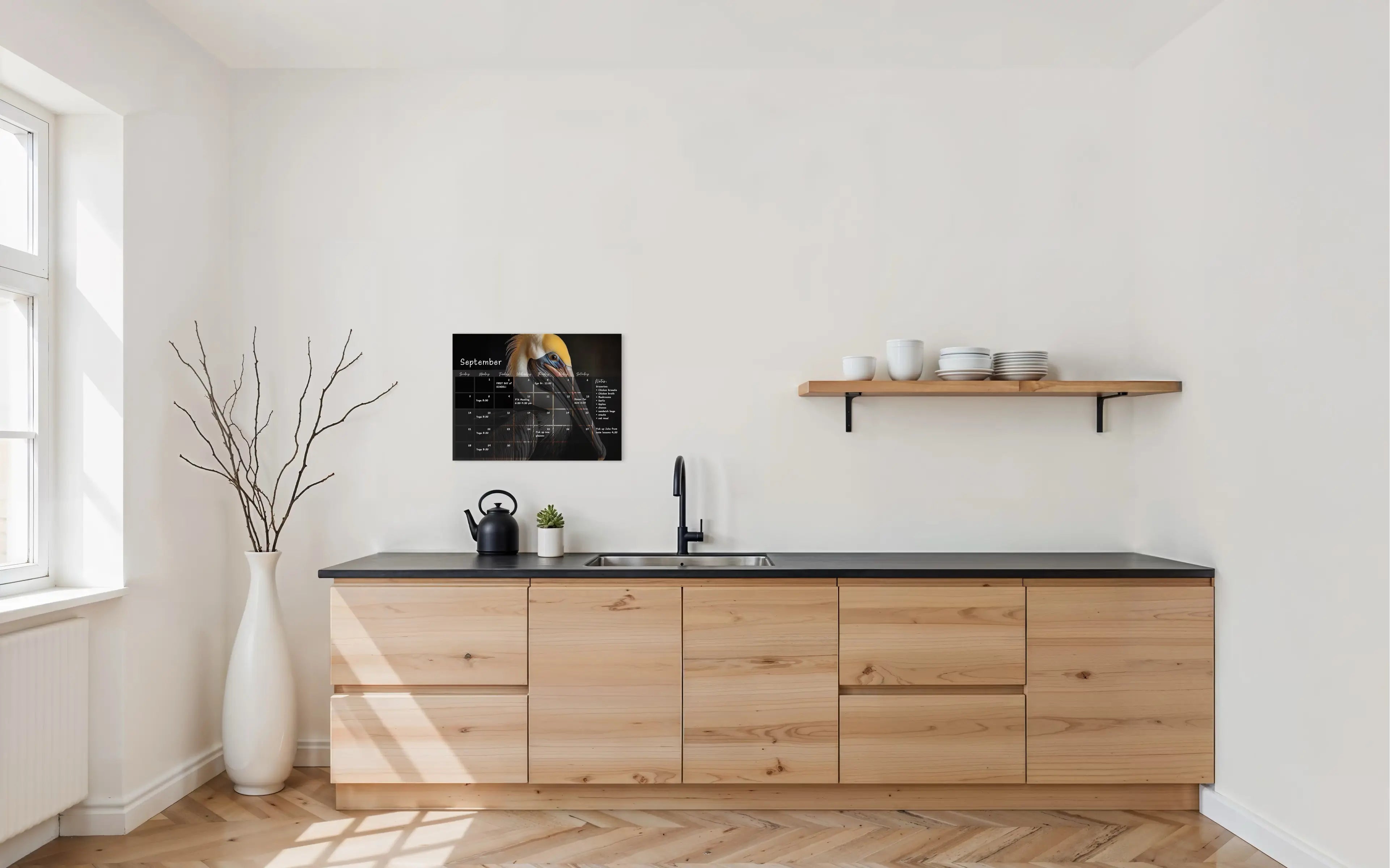 A dry-erase perpetual glass calendar featuring a dramatic, close-up portrait of a brown pelican on dark background, with monthly grid and a notes section.