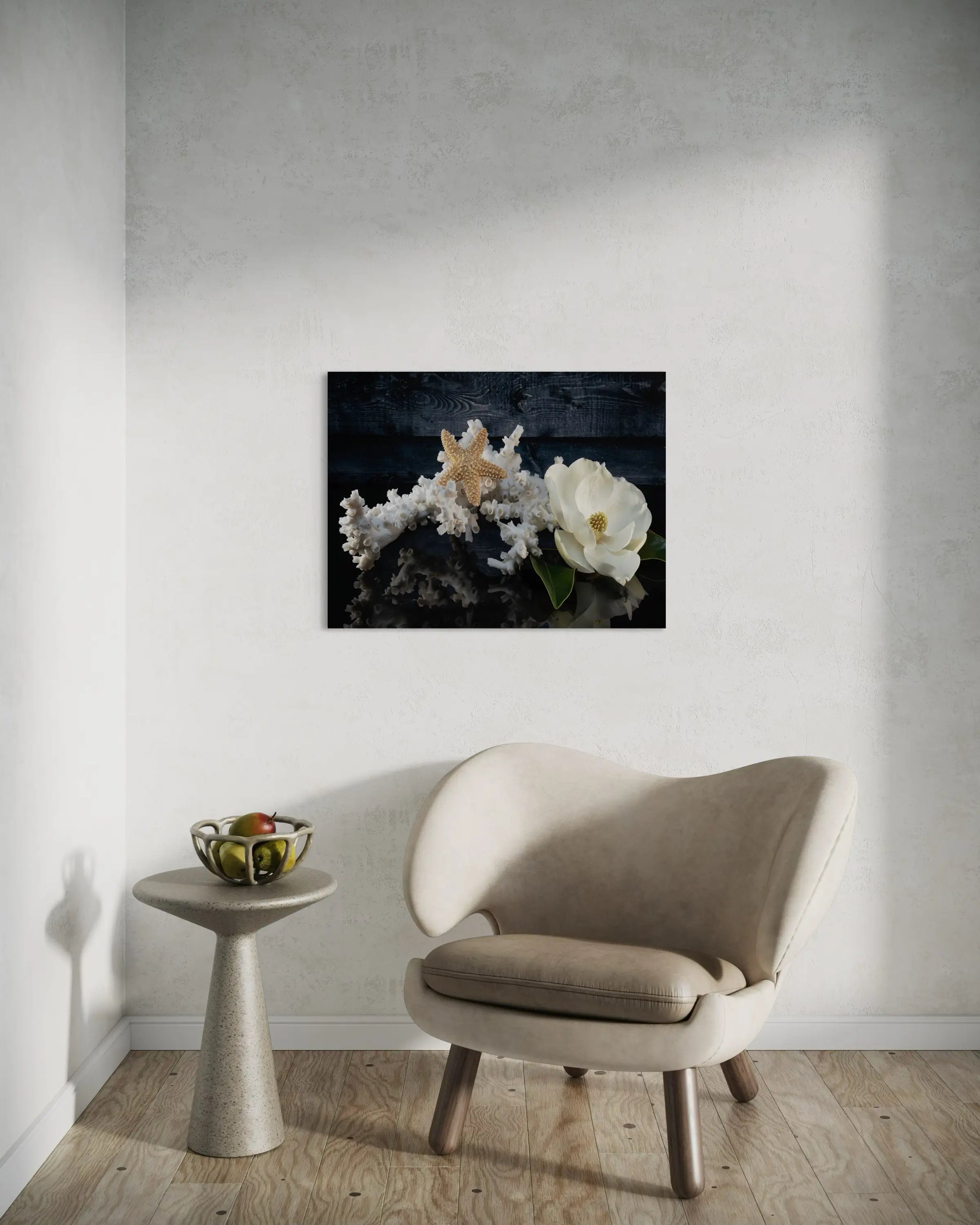 Glass print of octopus coral, starfish and a magnolia blossom on black reflective background, sitting area.