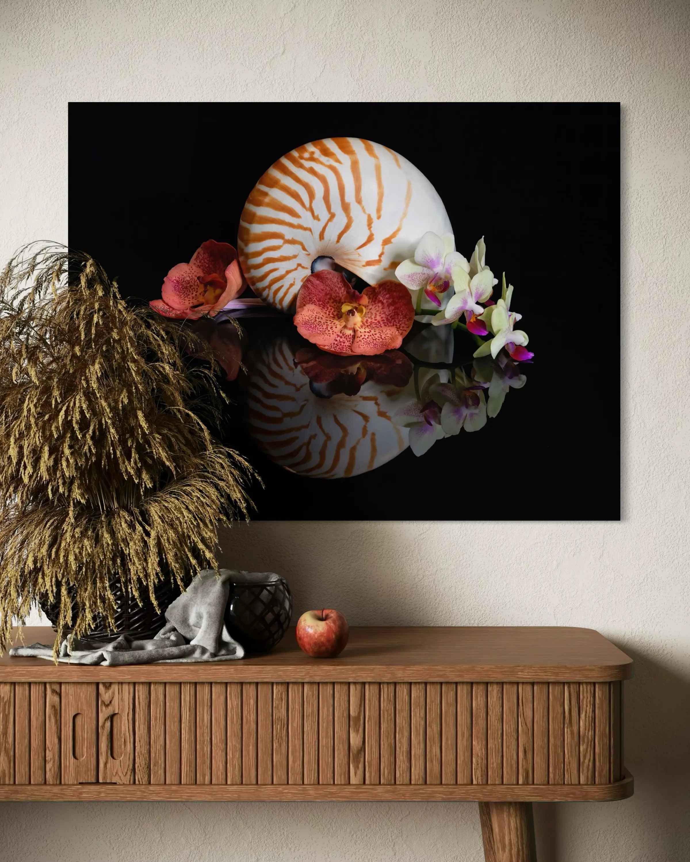 Coastal glass print of a chambered nautilus with deep orange orchids on black reflective surface above side table