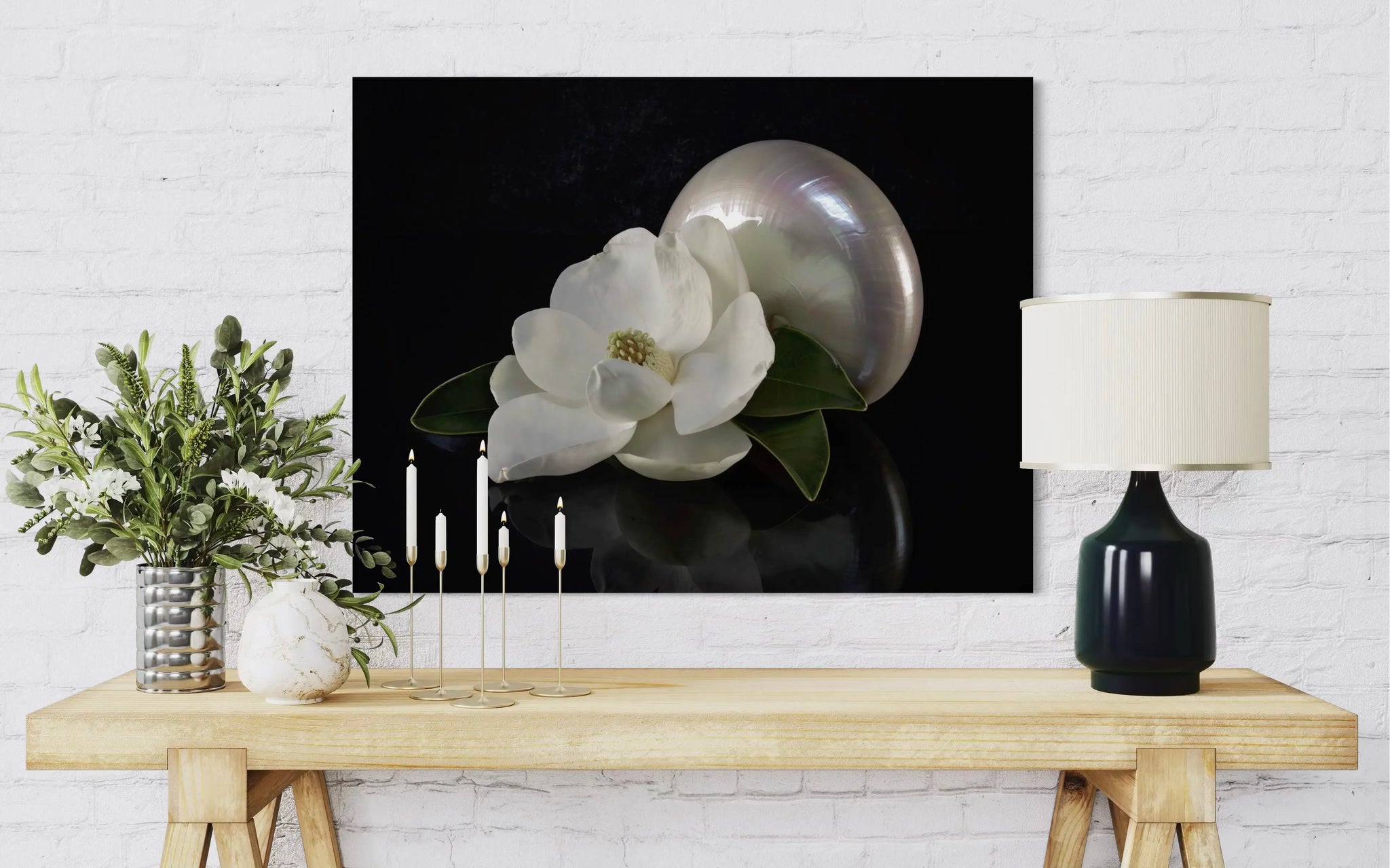 Eco-friendly glass print with magnolia blossom and pearl nautilus on reflective black background, perfect for coastal living room decor.