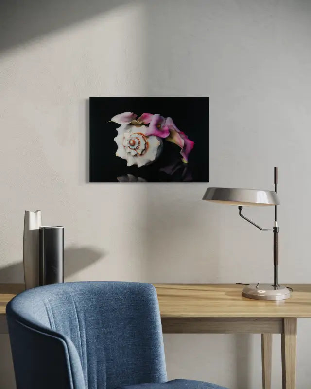 Pink calla lily and Triton’s Trumpet seashell on black coastal glass print, elegant botanical art, modern office decor.