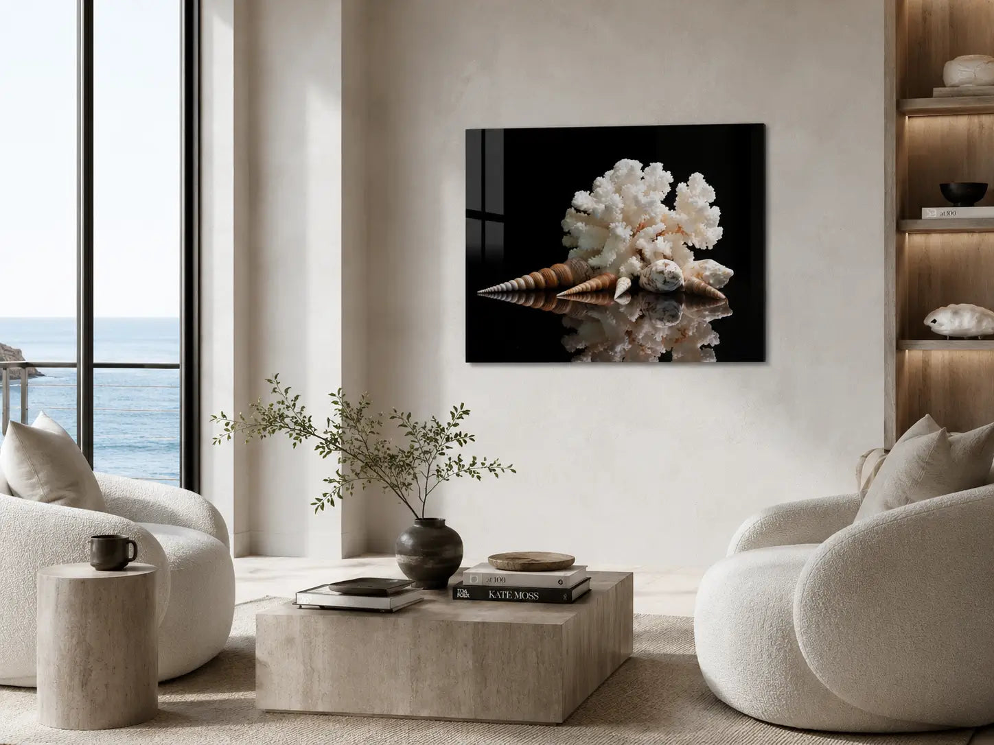 Modern coastal living room with white chairs, a coffee table, and a shell and coral glass print.