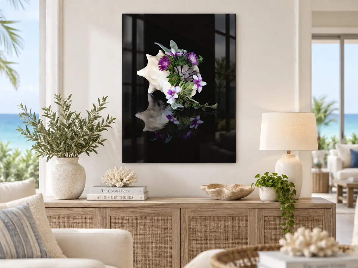 Conch Shell Botanical Coastal Wall Art displayed in a coastal living room, featuring a conch shell filled with succulents and purple flowers printed on frameless glass.