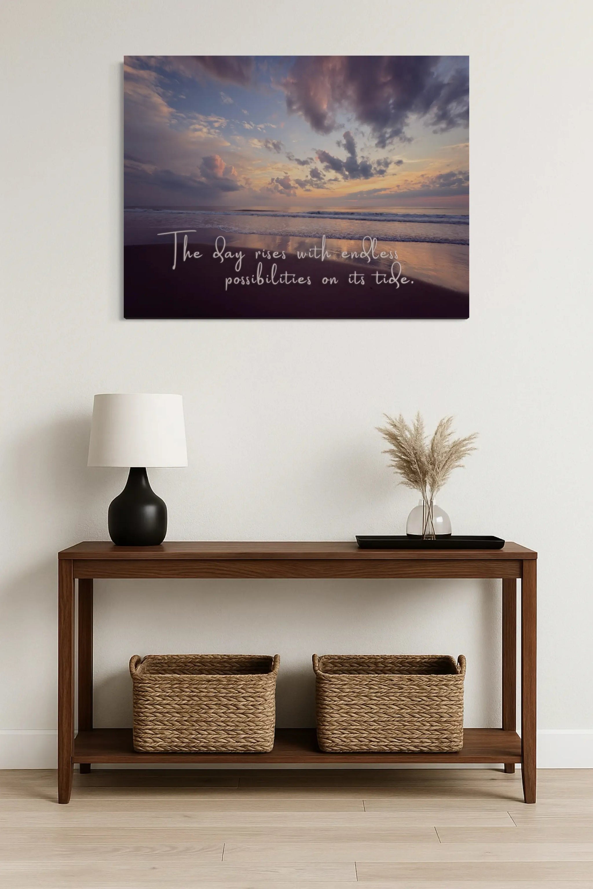 Coastal sunrise glass wall art with quote above entry table with wicker baskets – inspirational beach home entryway décor.