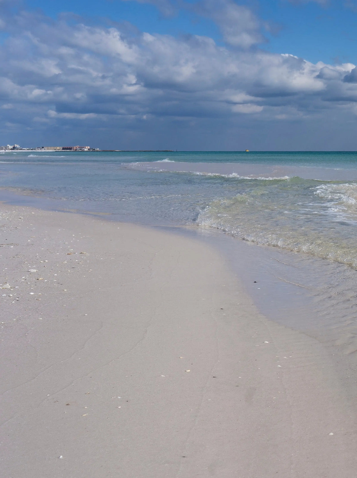 Left panel of Crystal Clear Beach Triptych showing white sand, shallow Gulf water, and clouds along Florida's Emerald Coast