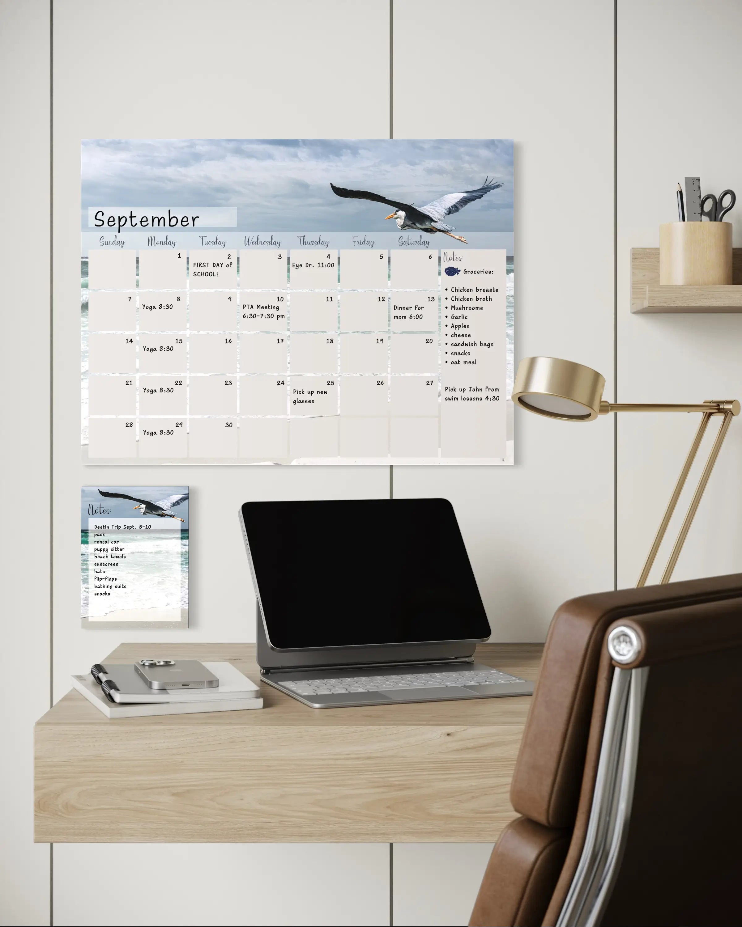 A reusable glass notes board featuring a Great Blue Heron in flight over ocean waves, with a blank dry-erase surface for notes and to-do lists with matching calendars