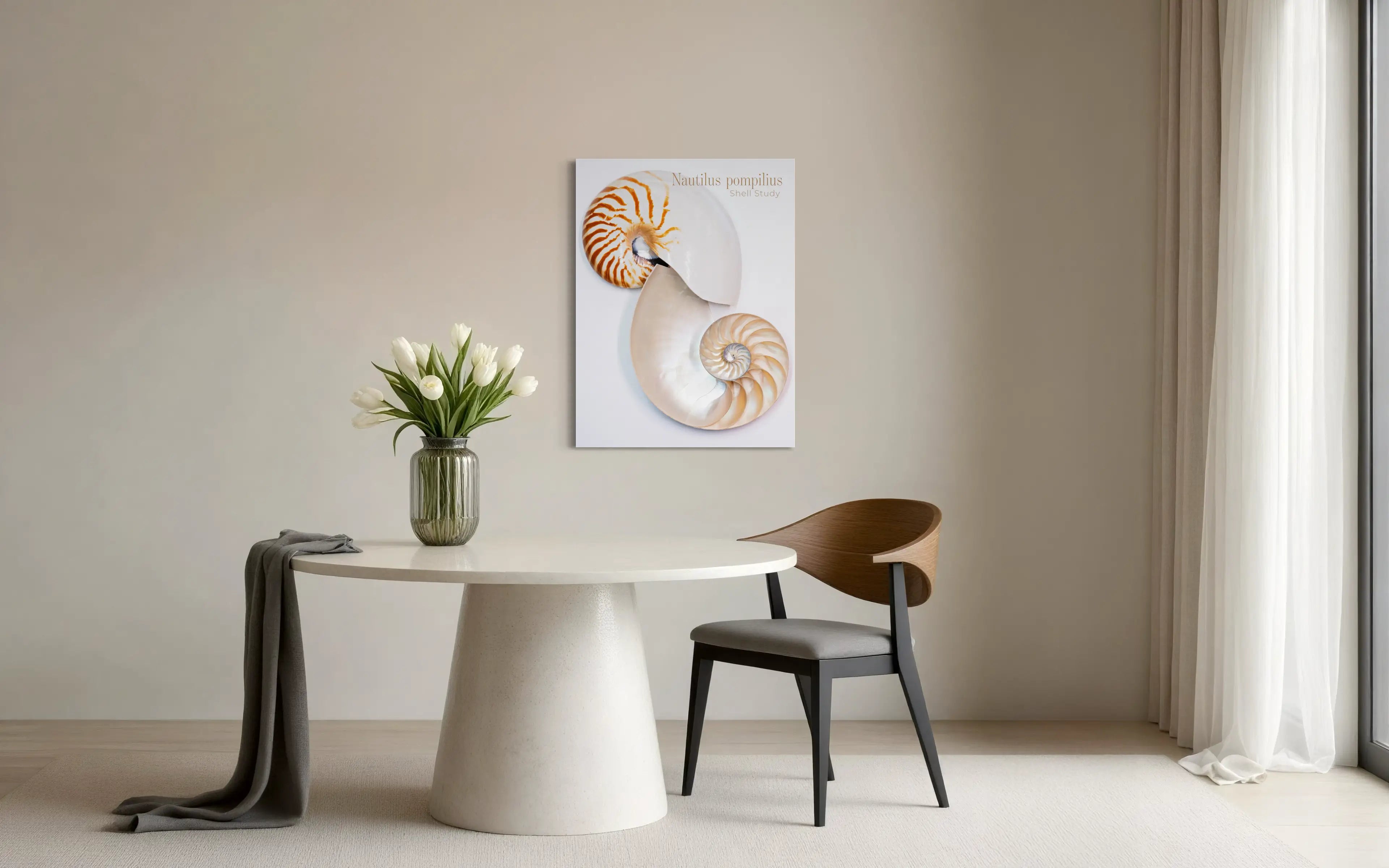 Nautilus shell glass wall art displayed above a modern dining table in a minimal coastal interior